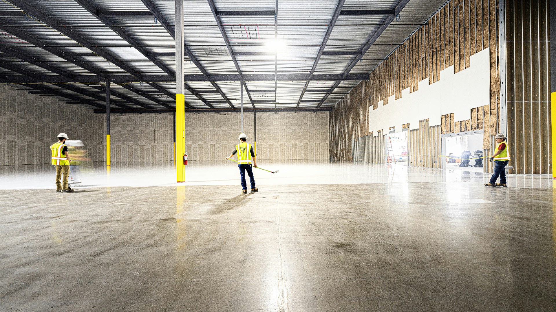 Workers standing on a hard concrete warehouse floor