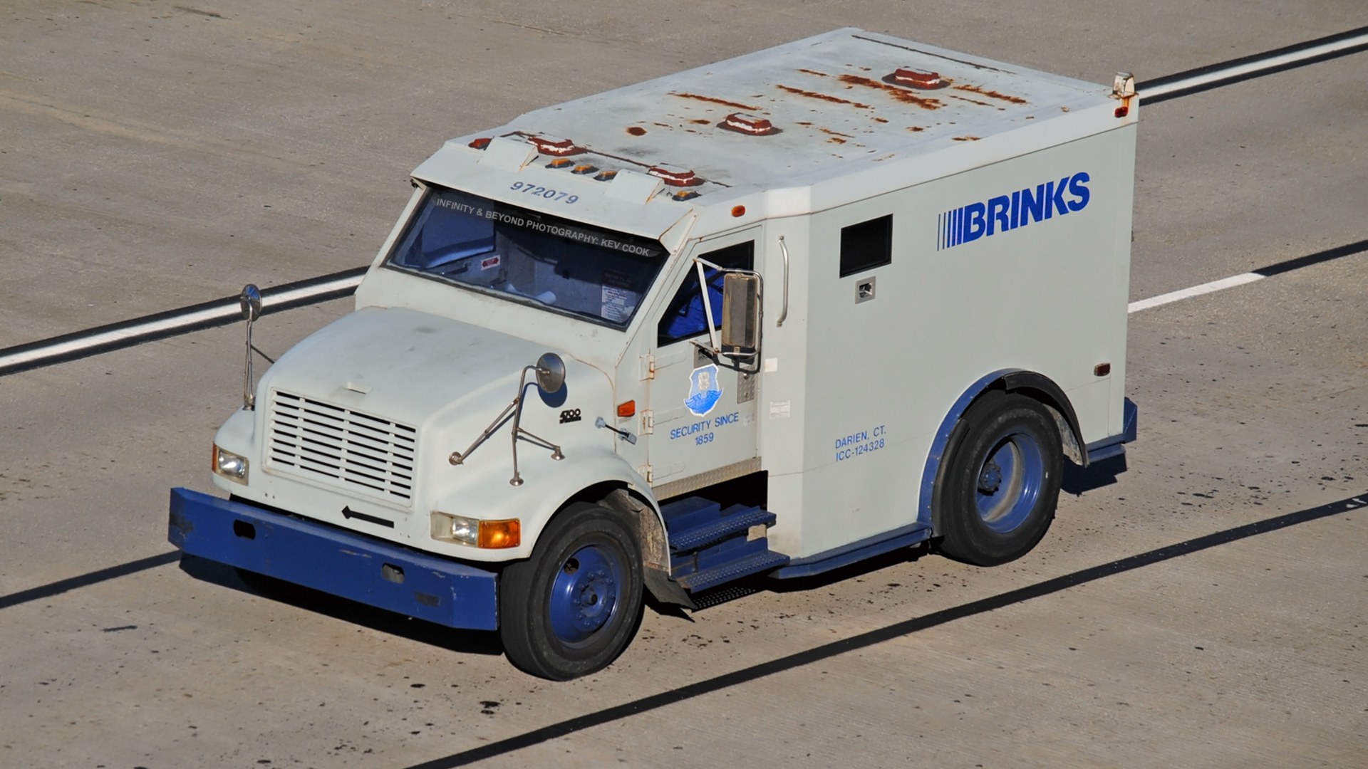 A Brink's armored bank truck parked on a city street.