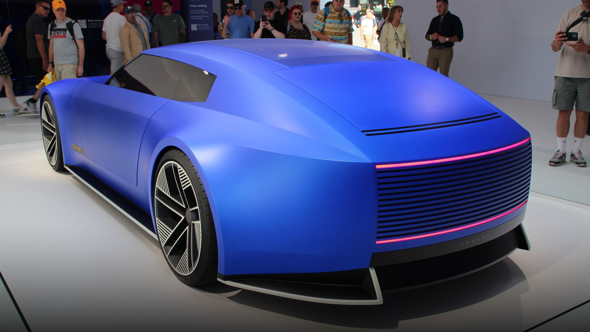 Sculpted boat-tail rear of the Jaguar Type 00 with horizontal glowing taillight bars and aerodynamic diffuser.