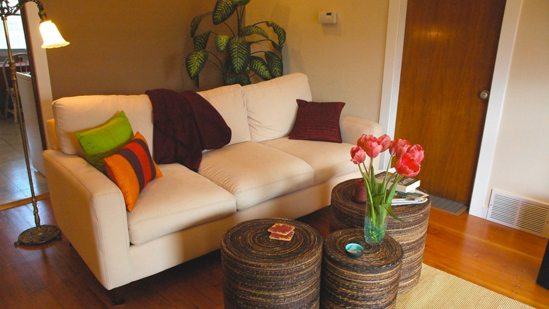Cozy living room with jute area rug, white sofa, and floor lamp