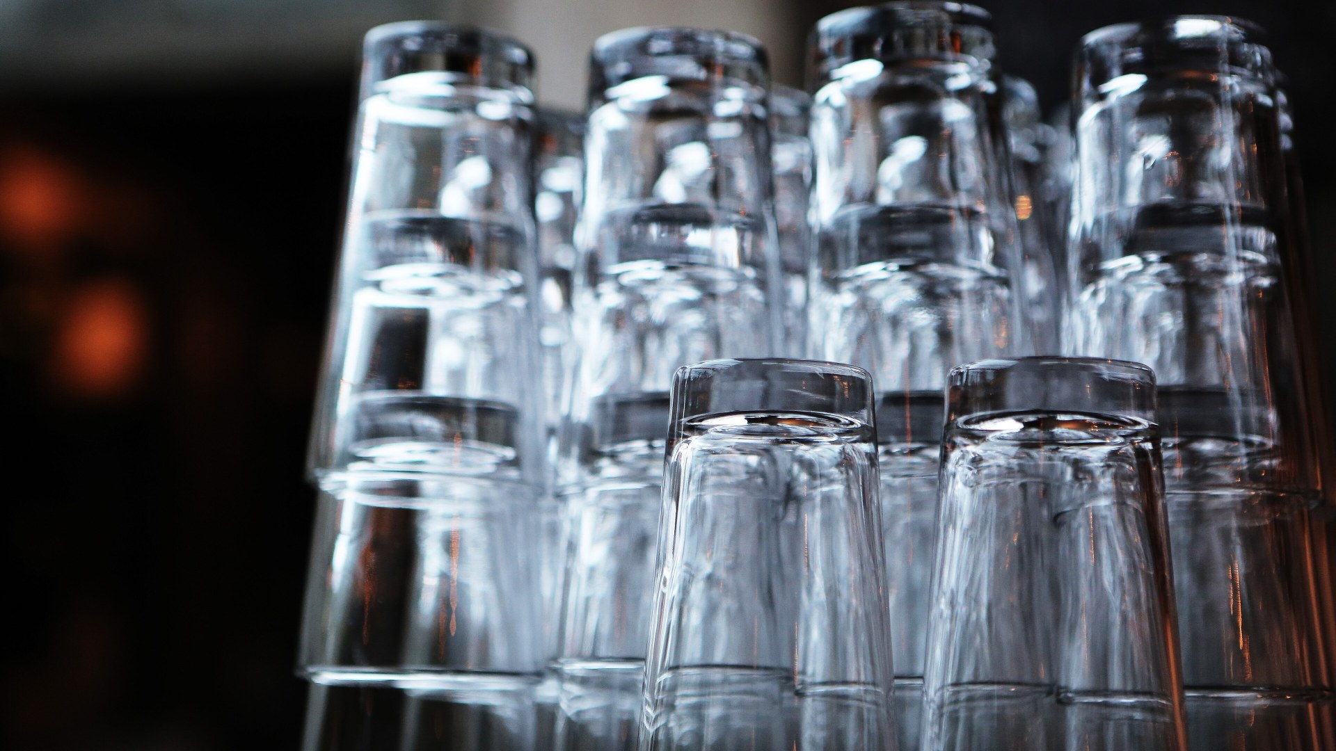 Row of alcoholic drinks and cocktail glasses on a bar counter