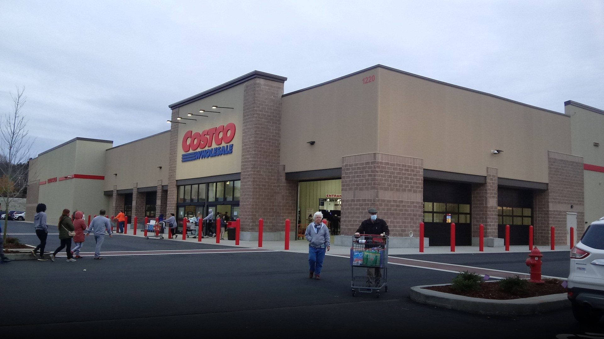 Photograph of Costco Wholesale supermarket storefront celebrating family grocery excellence.
