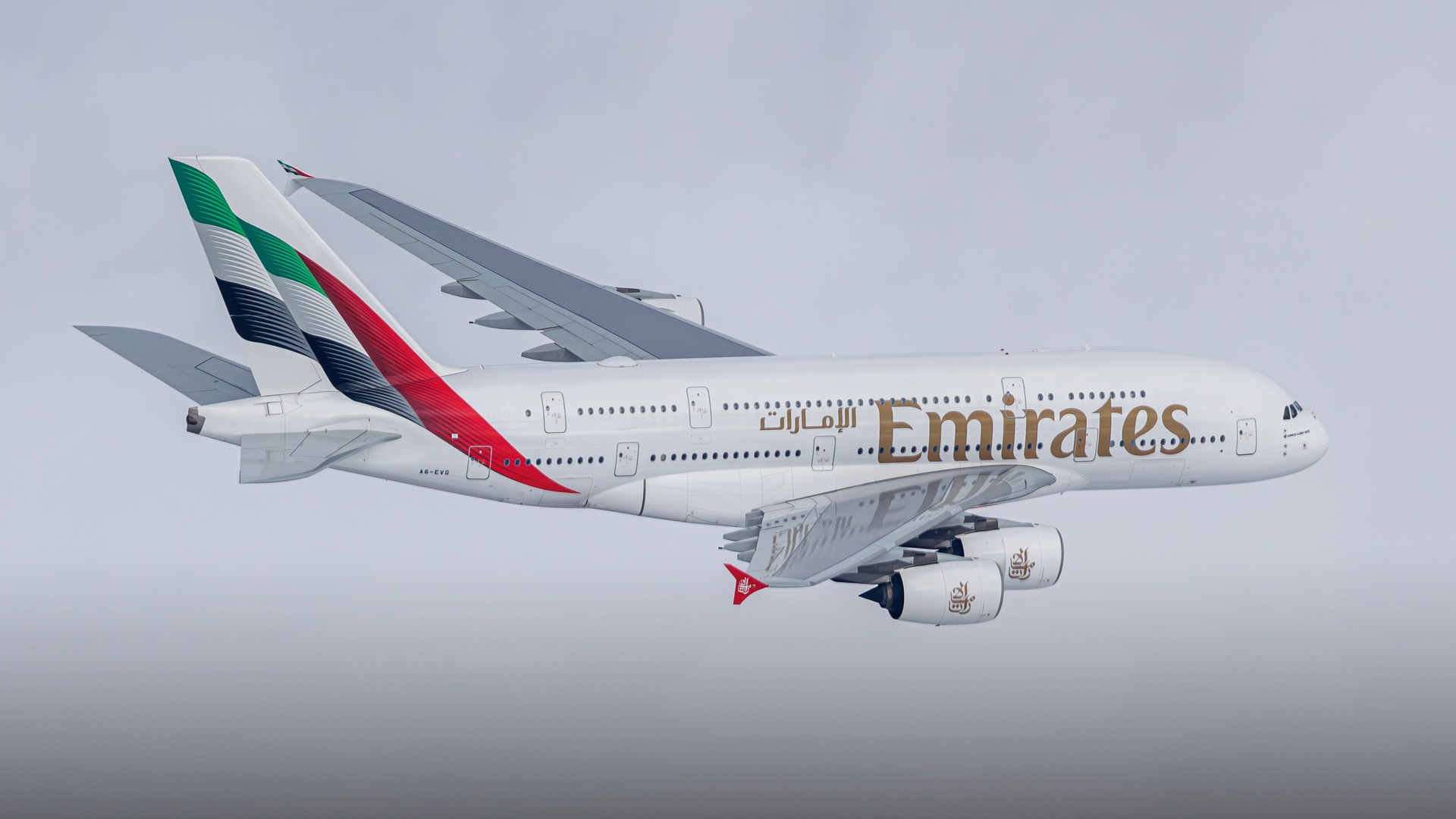 A double-decker Emirates Airbus A380 superjumbo cruising smoothly at high cruising altitude.