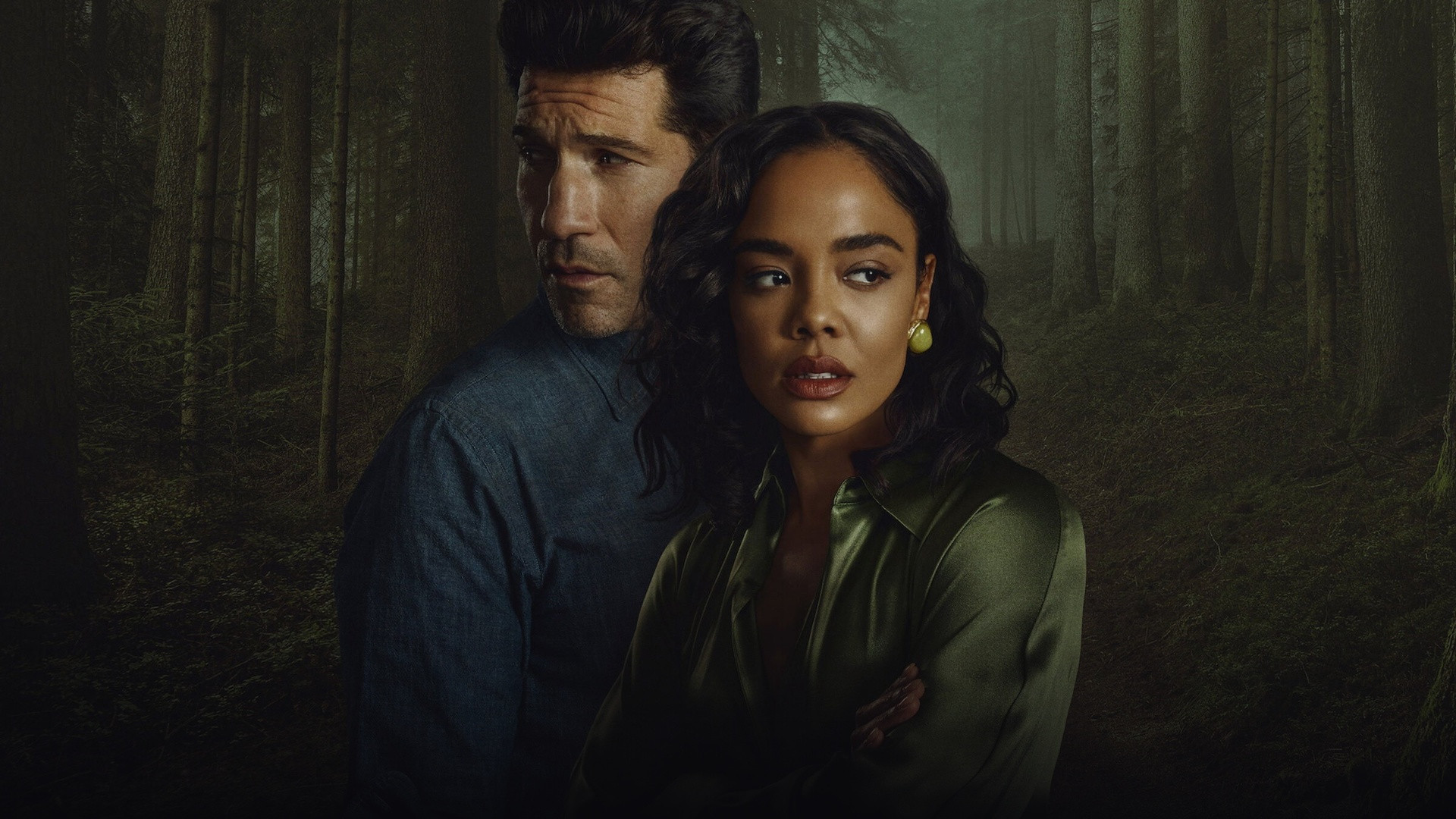 Tessa Thompson and Jon Bernthal standing back-to-back in an atmospheric misty forest setting.