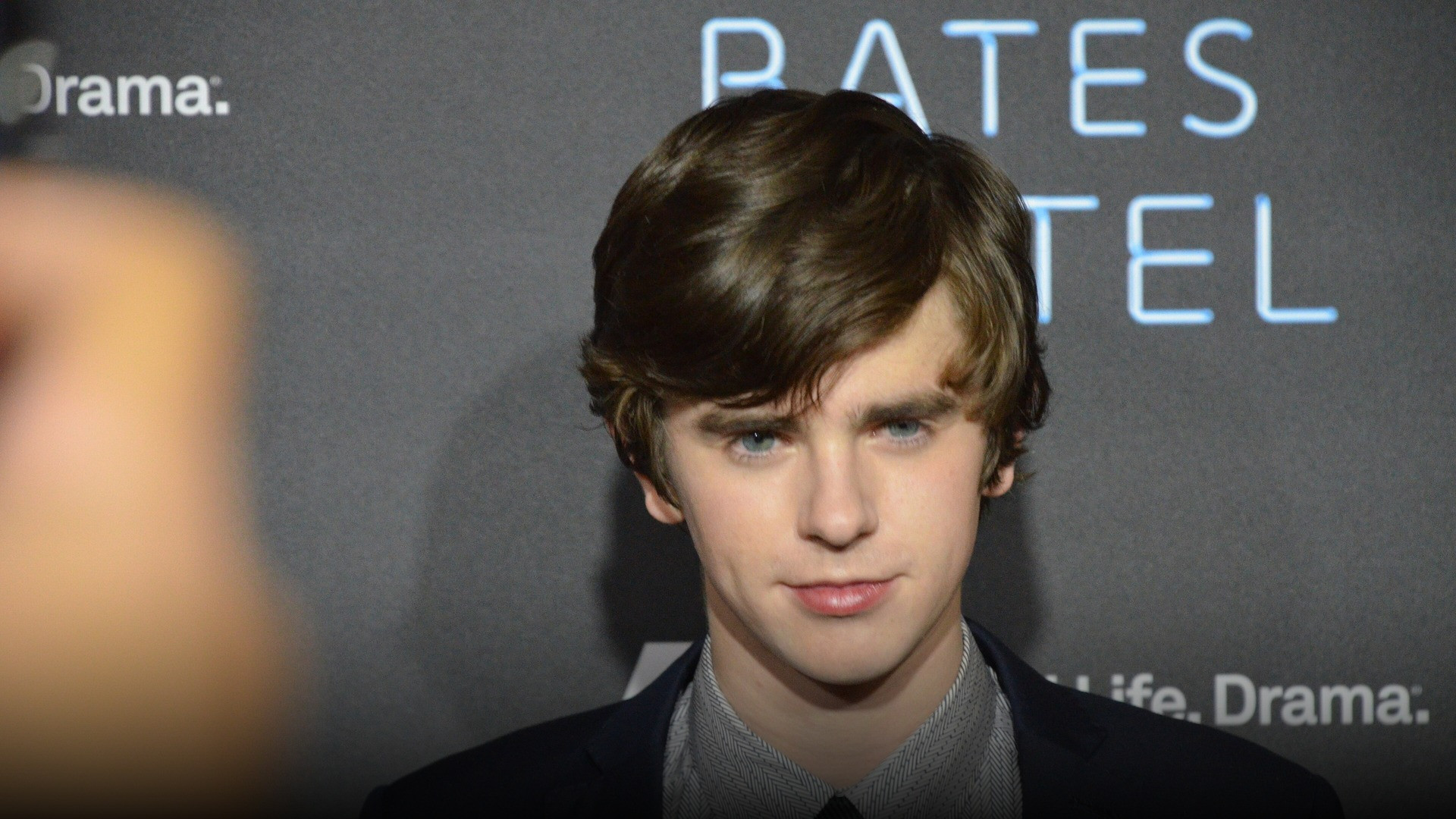 High-resolution portrait photograph of Freddie Highmore celebrating academic achievement.