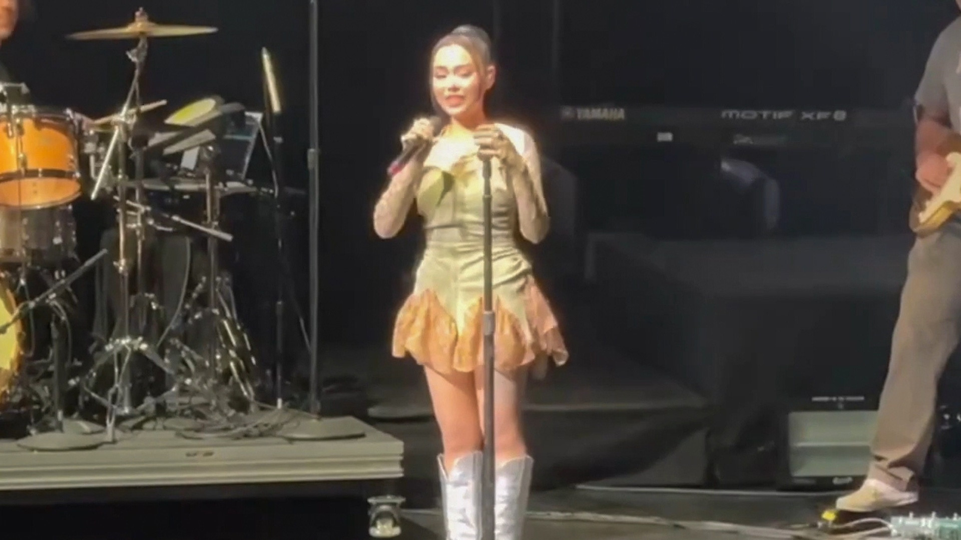 Musician and viral creator Bella Poarch performing live on stage.