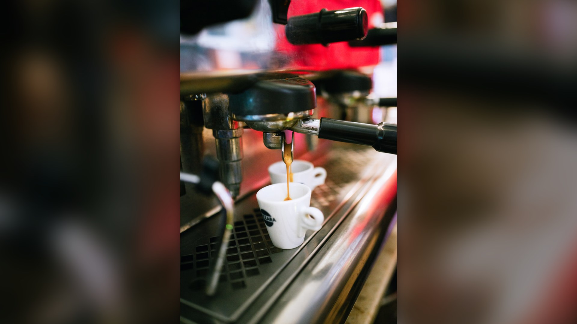 Espresso machine pouring two shots of coffee into small cups