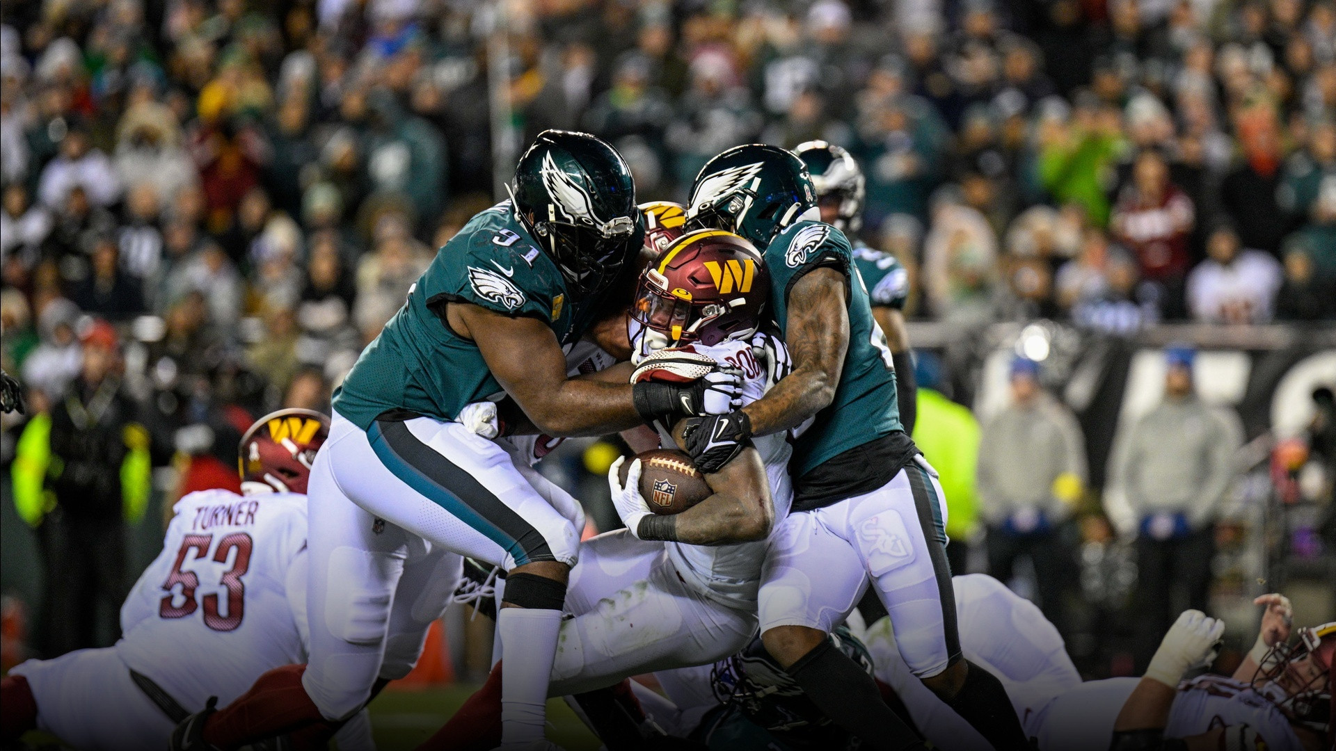 Philadelphia Eagles players gathering on the field during a game.