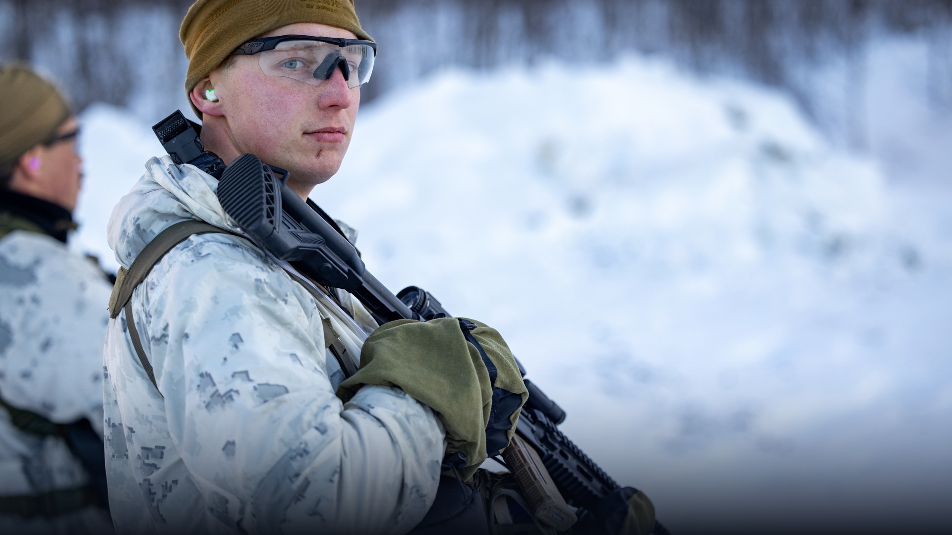Military reconnaissance patrol conducting cold-weather operations in deep Arctic snow.
