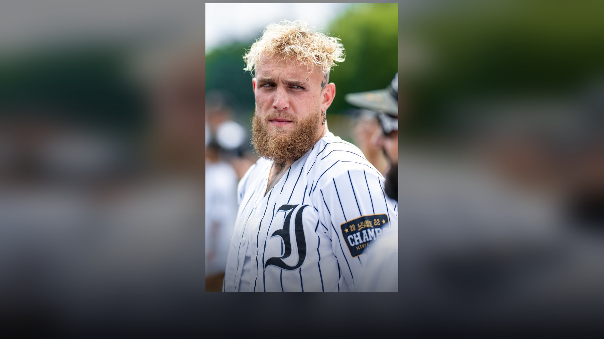 Jake Paul wearing a sports jersey at a public appearance.