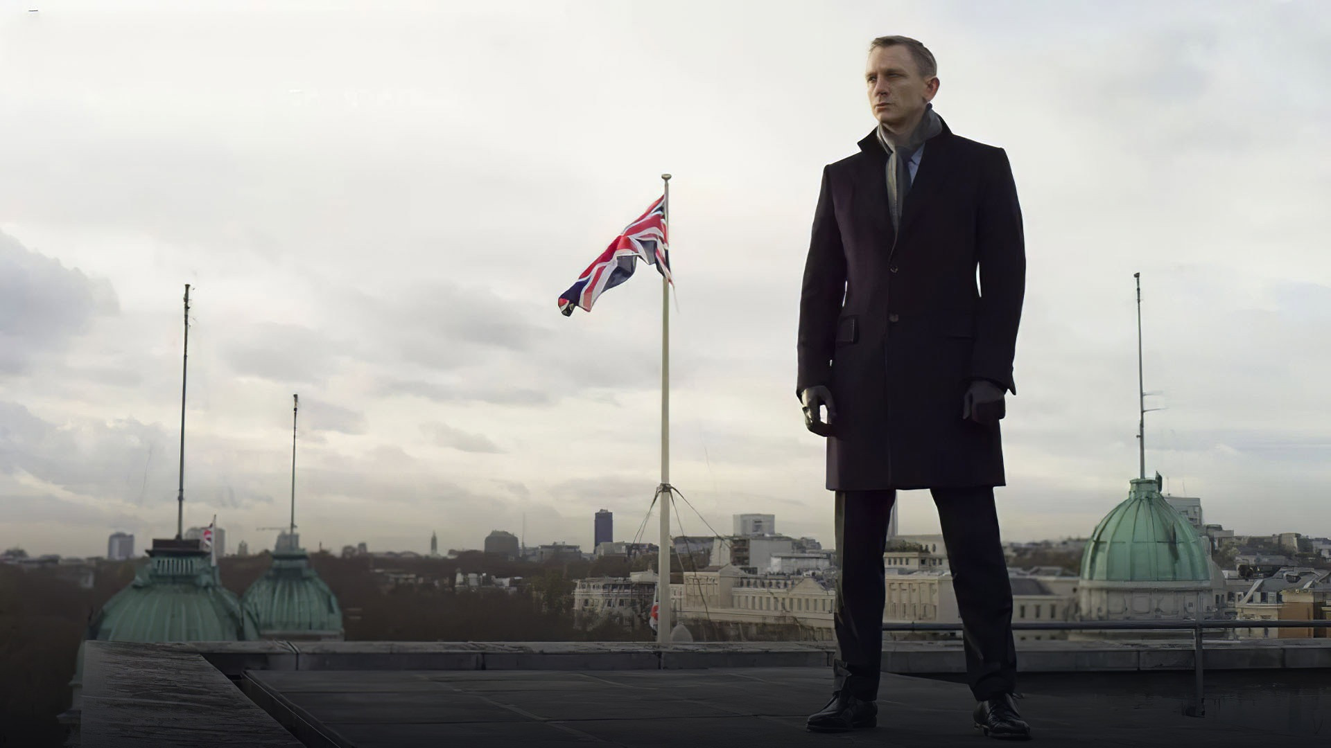 James Bond standing beside his Aston Martin DB5 in Skyfall.