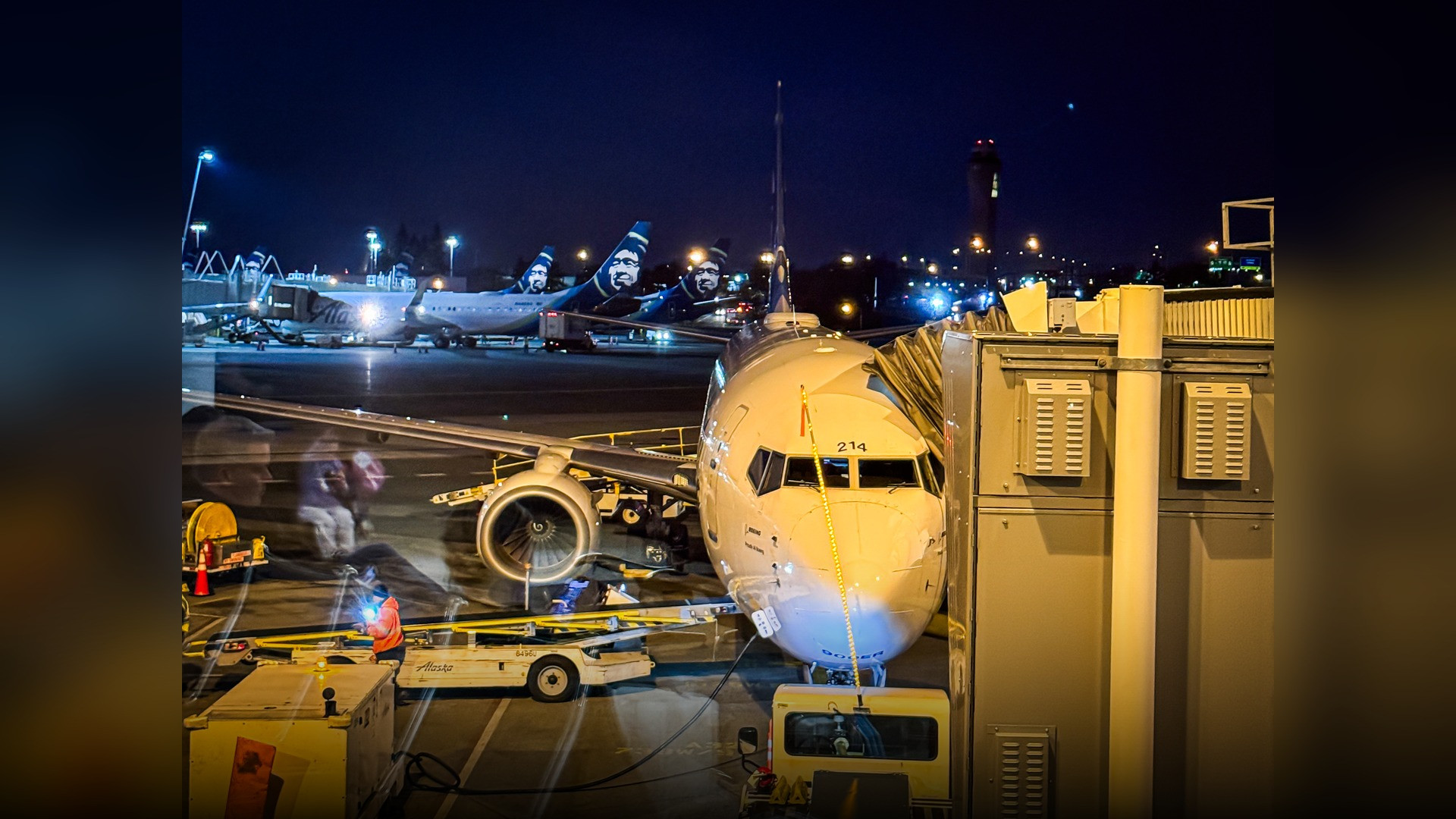 The elevated international arrivals pedestrian skybridge spanning over aircraft taxiways at Seattle-Tacoma International Airport.