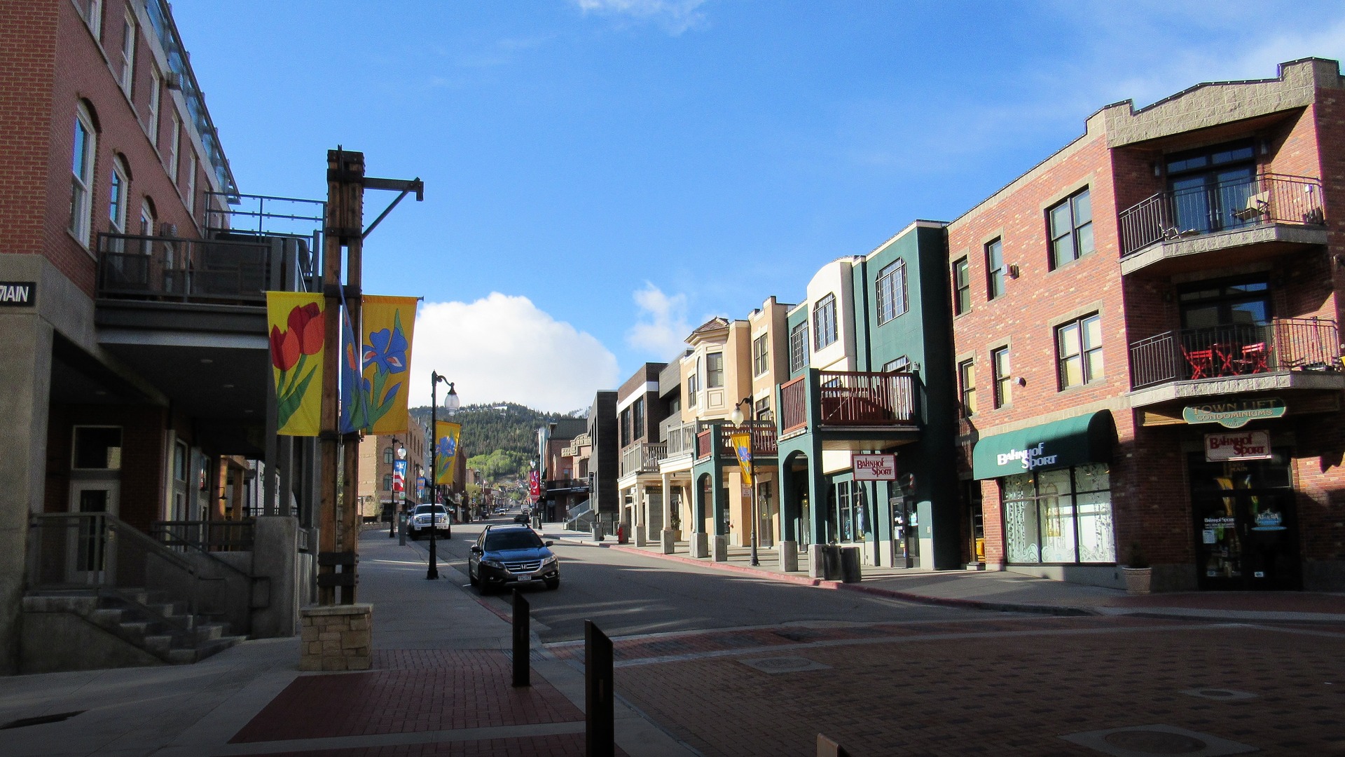Historic Main Street in Park City Utah blanketed in fresh snow with snow-covered Wasatch mountain slopes behind.