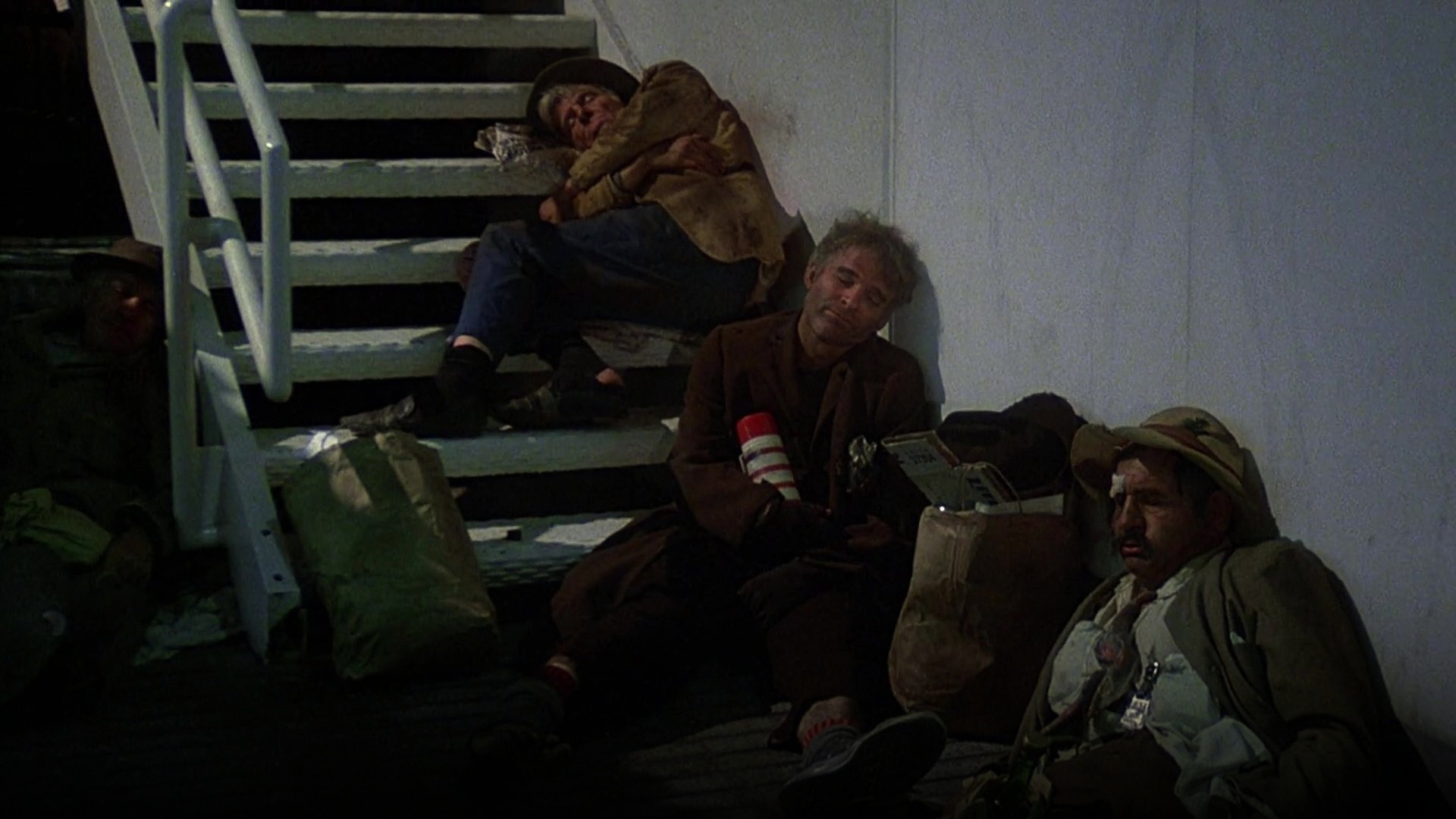 Steve Martin as Navin R. Johnson smiling ecstatically in his eccentric work overalls in The Jerk.