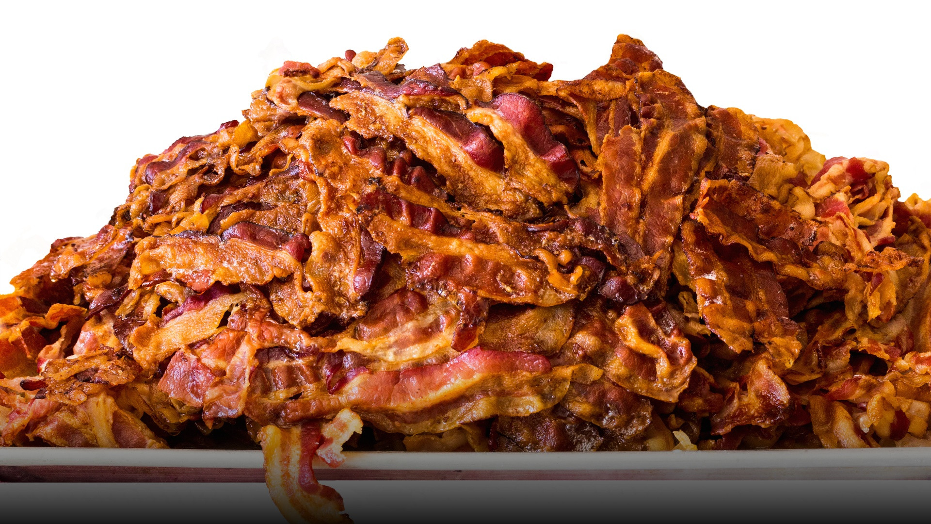 A generous stack of freshly cooked, crispy golden-brown bacon strips.