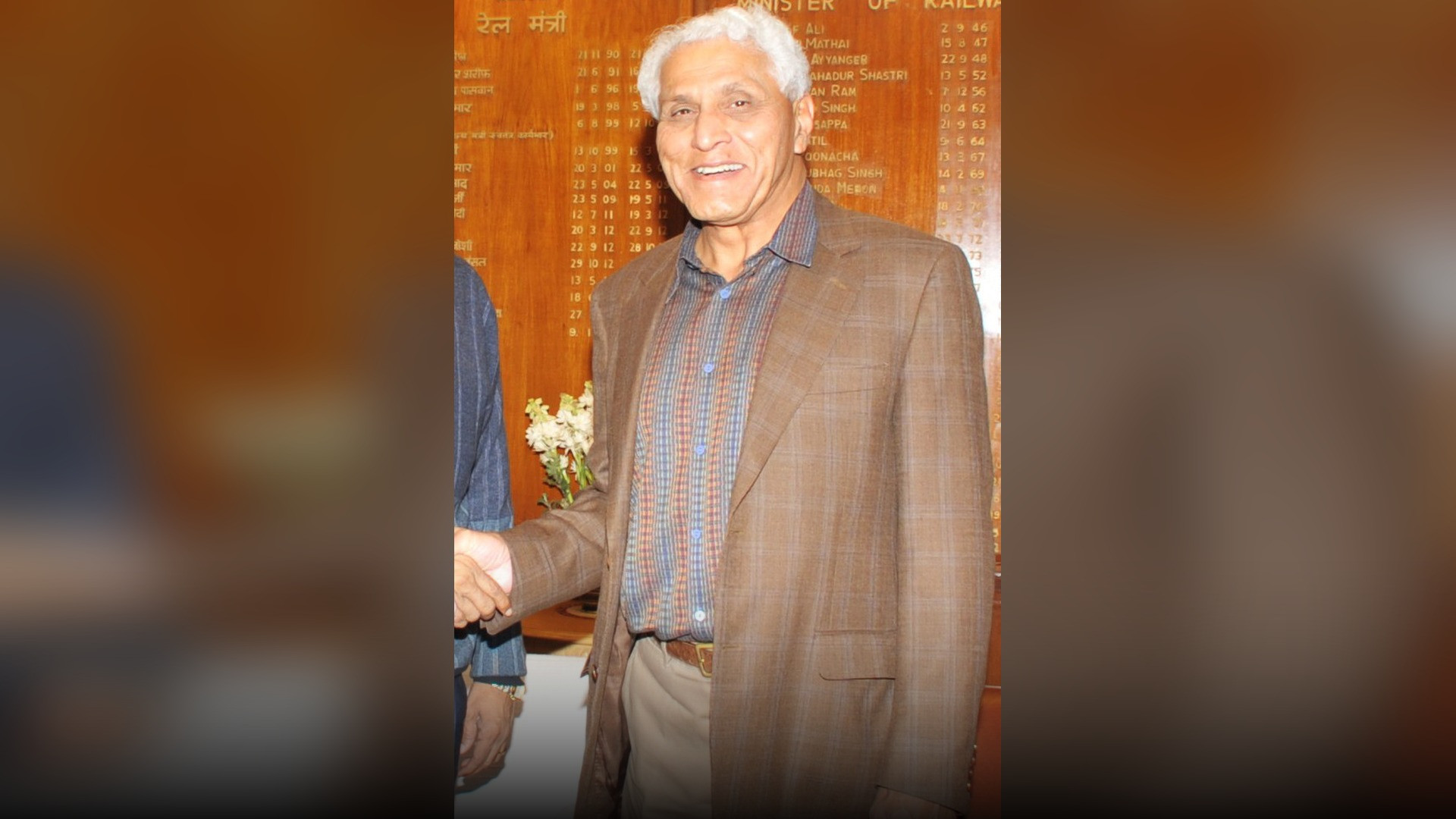 Dr. Romesh Wadhwani in a professional business suit.