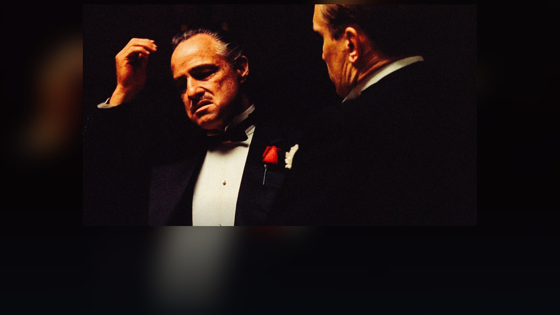 Marlon Brando seated in his study as Don Vito Corleone in The Godfather.