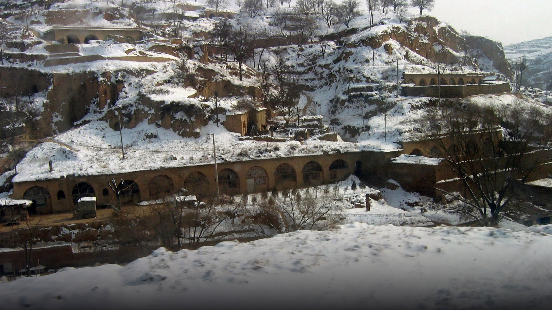 Traditional yaodong cave dwellings dug into the hillsides of the Loess Plateau in rural Shaanxi.