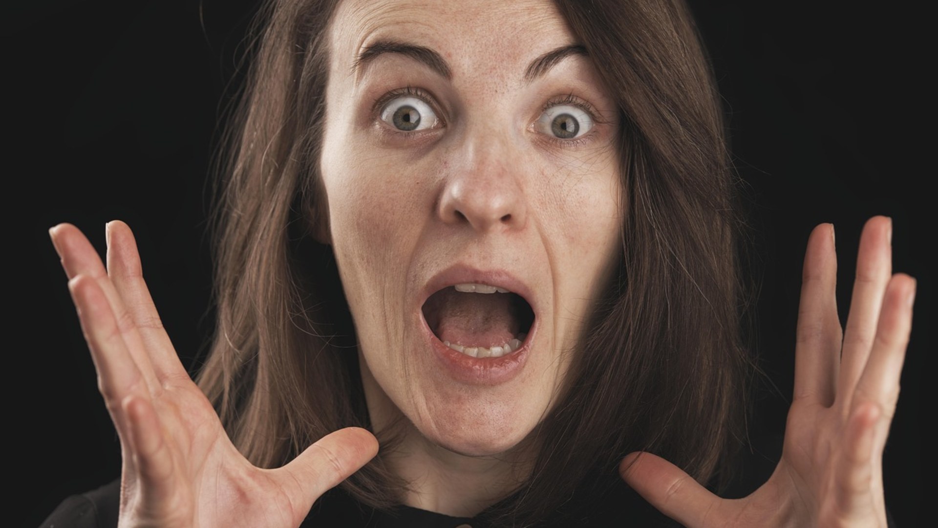 Woman making an exaggerated, theatrical surprised expression