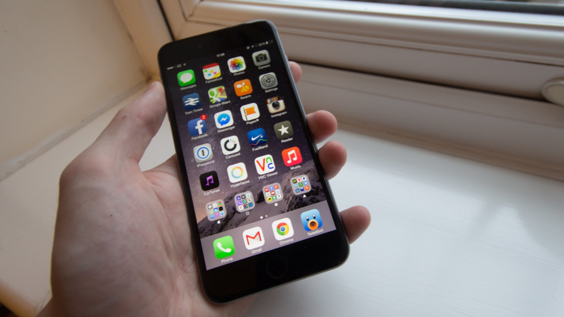 iPhone 6 Plus held in hand showing large screen — Apple's best-selling smartphone series