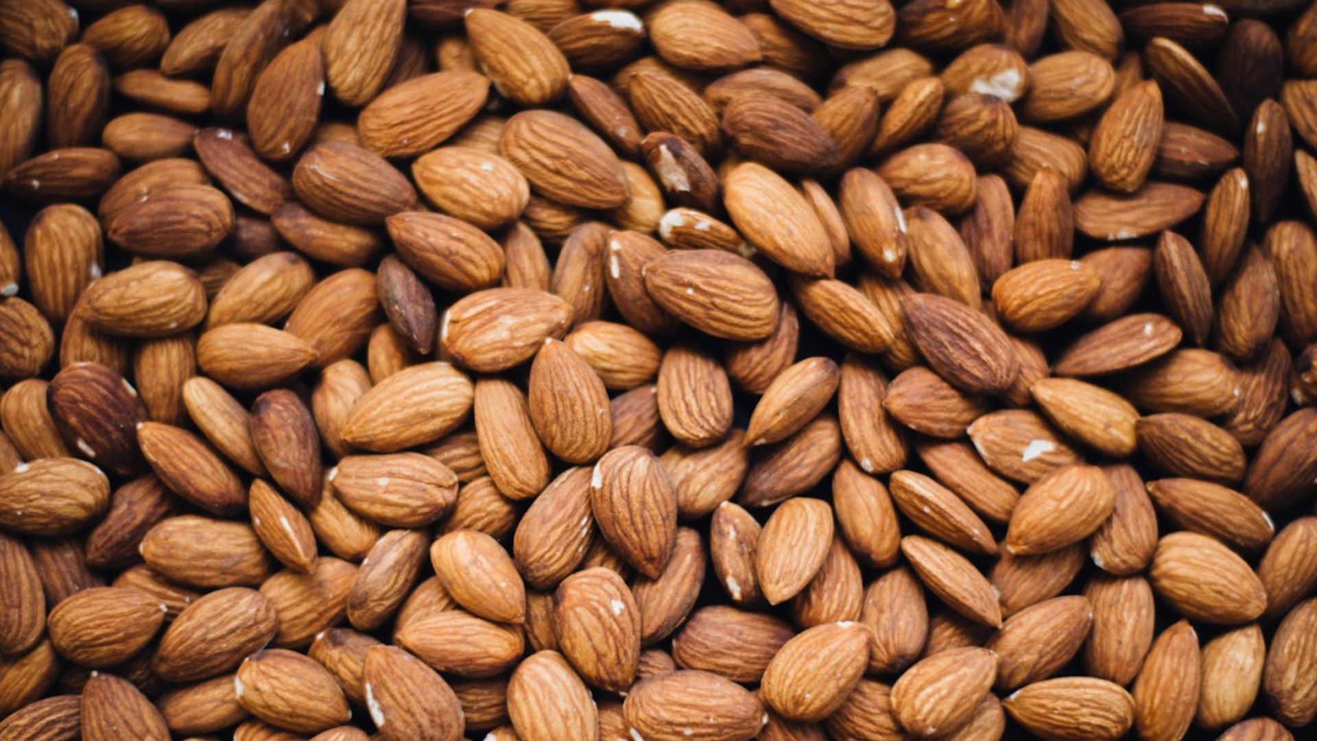 Pile of raw almonds on a surface