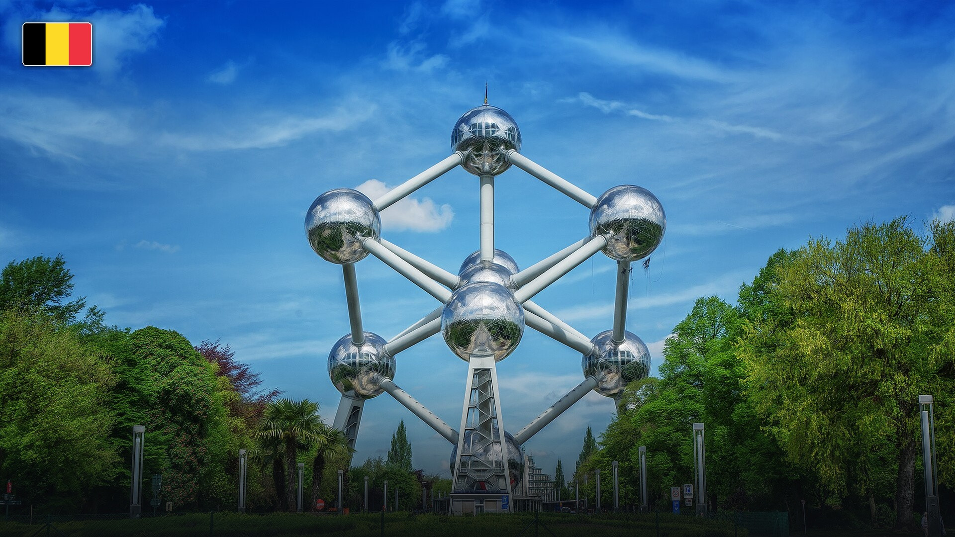The futuristic stainless steel spheres of the Atomium in Brussels, with the flag of Belgium.