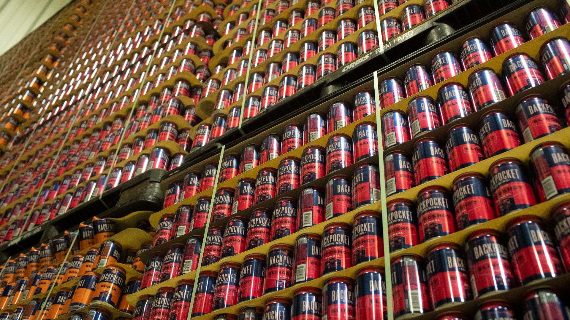 Row of empty and unopened canned beverages