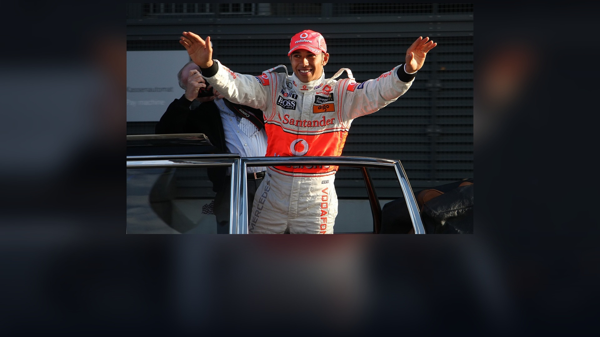 Formula 1 world champion Lewis Hamilton in the cockpit actively steering at speed.