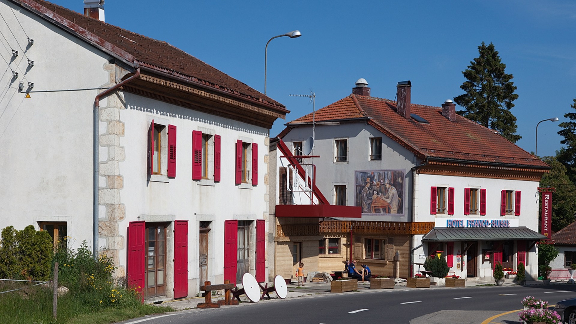 Landscape photograph of Hotel Arbez Franco-Suisse standing directly across the French-Swiss border in La Cure.