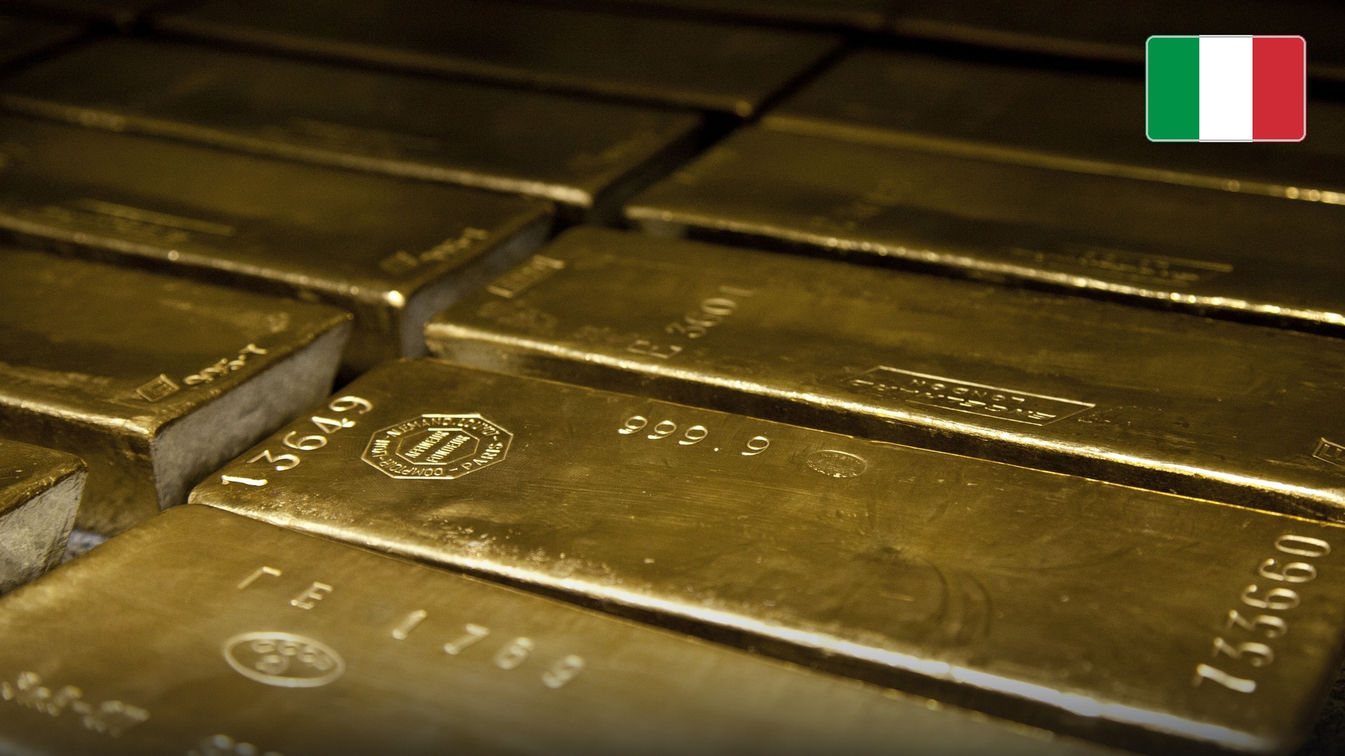 Rows of certified 400-troy-ounce central bank gold bullion bars in vault storage. Official national flag badge in top right.