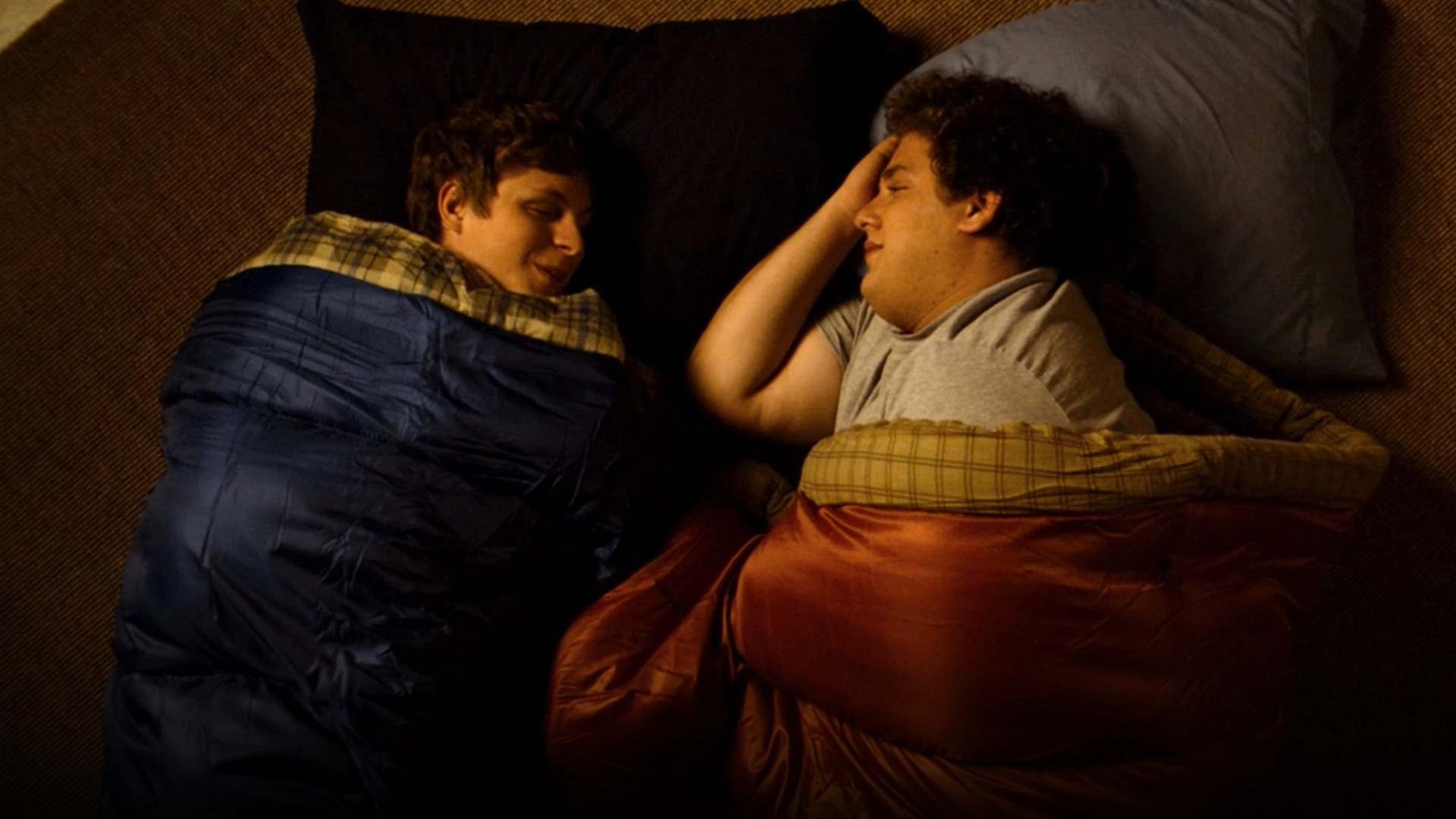 Jonah Hill as Seth, Michael Cera as Evan, and Christopher Mintz-Plasse as McLovin posing together in Superbad.
