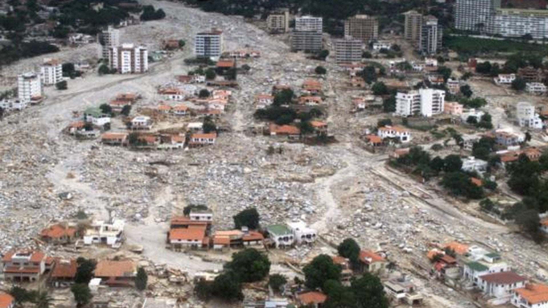 Aerial view of massive boulder and mudflow deposits burying coastal apartment buildings in Caraballeda after the 1999 Vargas tragedy in Venezuela.