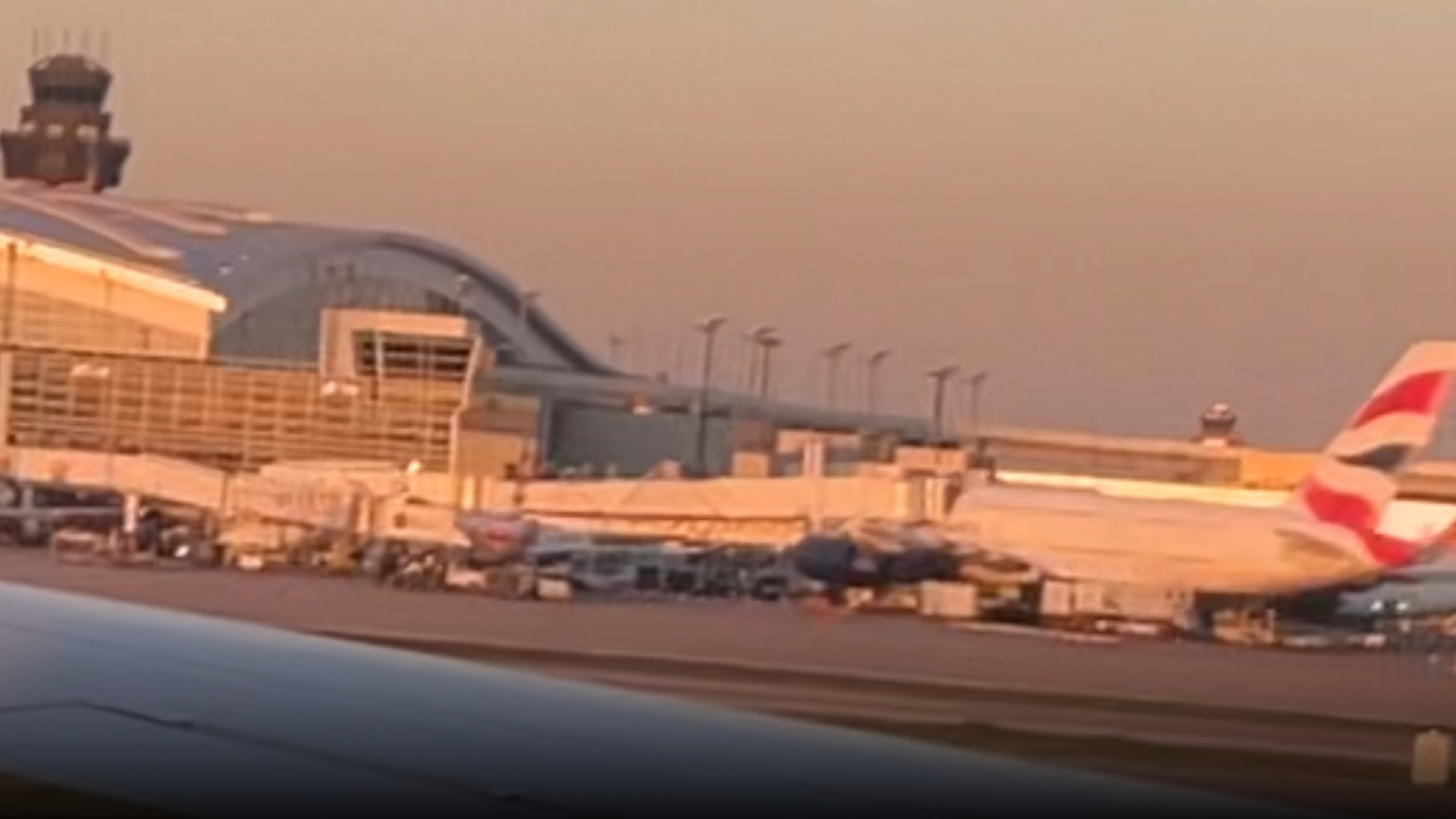 American Airlines Boeing 737 aircraft parked at the curved passenger terminal gates at Dallas/Fort Worth International Airport.