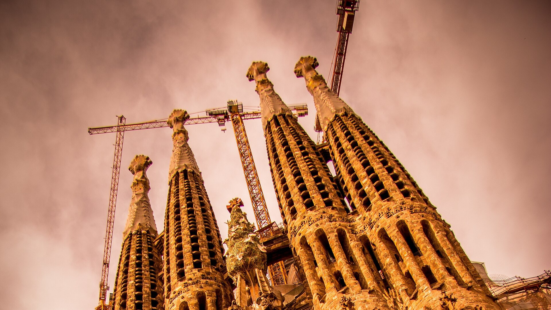 The soaring stone spires and sculpted Nativity facade of Antoni Gaudi's La Sagrada Familia in Barcelona.