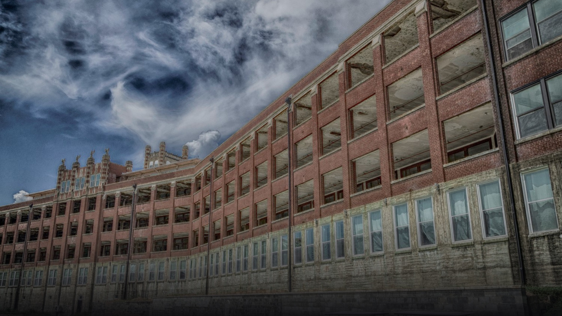 Massive early-20th-century Gothic tuberculosis hospital facade with long open-air solarium porches in Louisville, Kentucky.