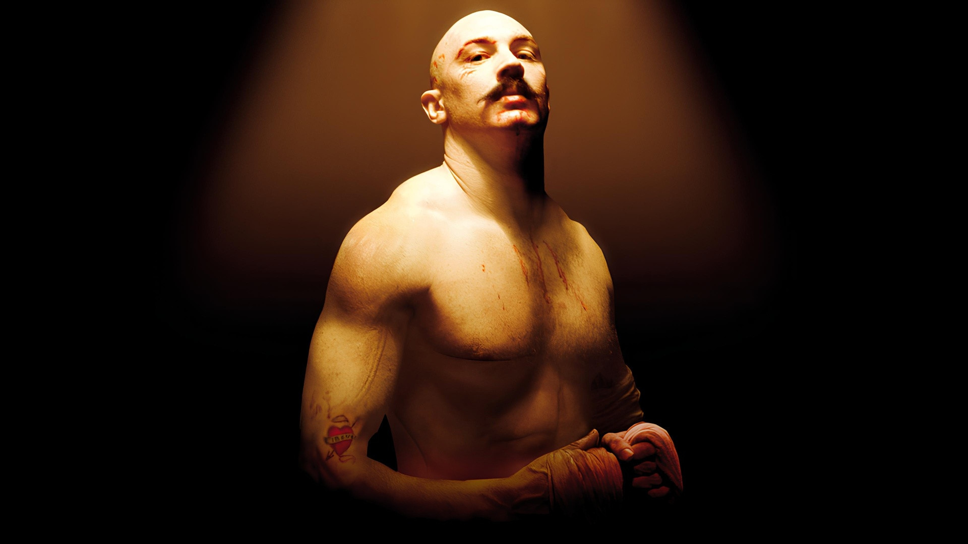 Tom Hardy muscular and bulked up with a mustache in Bronson.