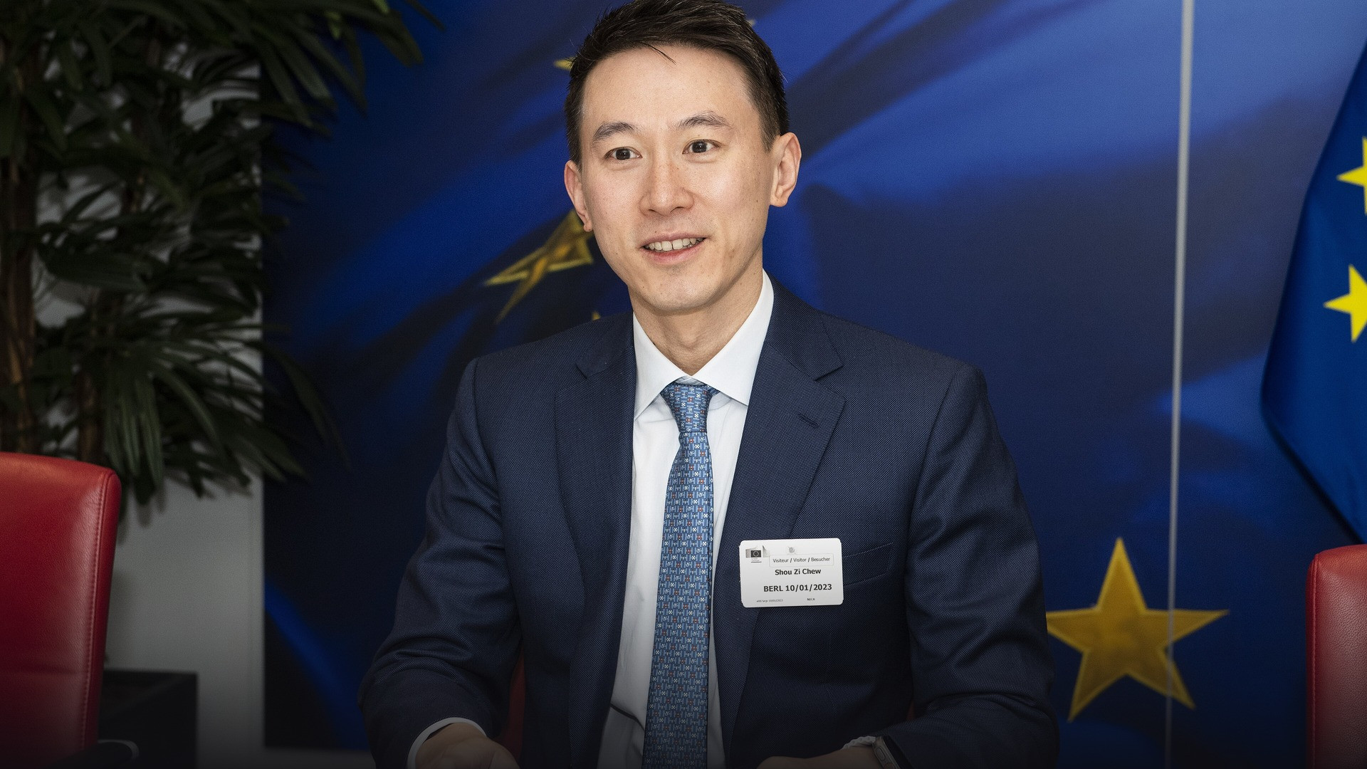 TikTok Chief Executive Officer Shou Zi Chew seated at a formal international press conference.