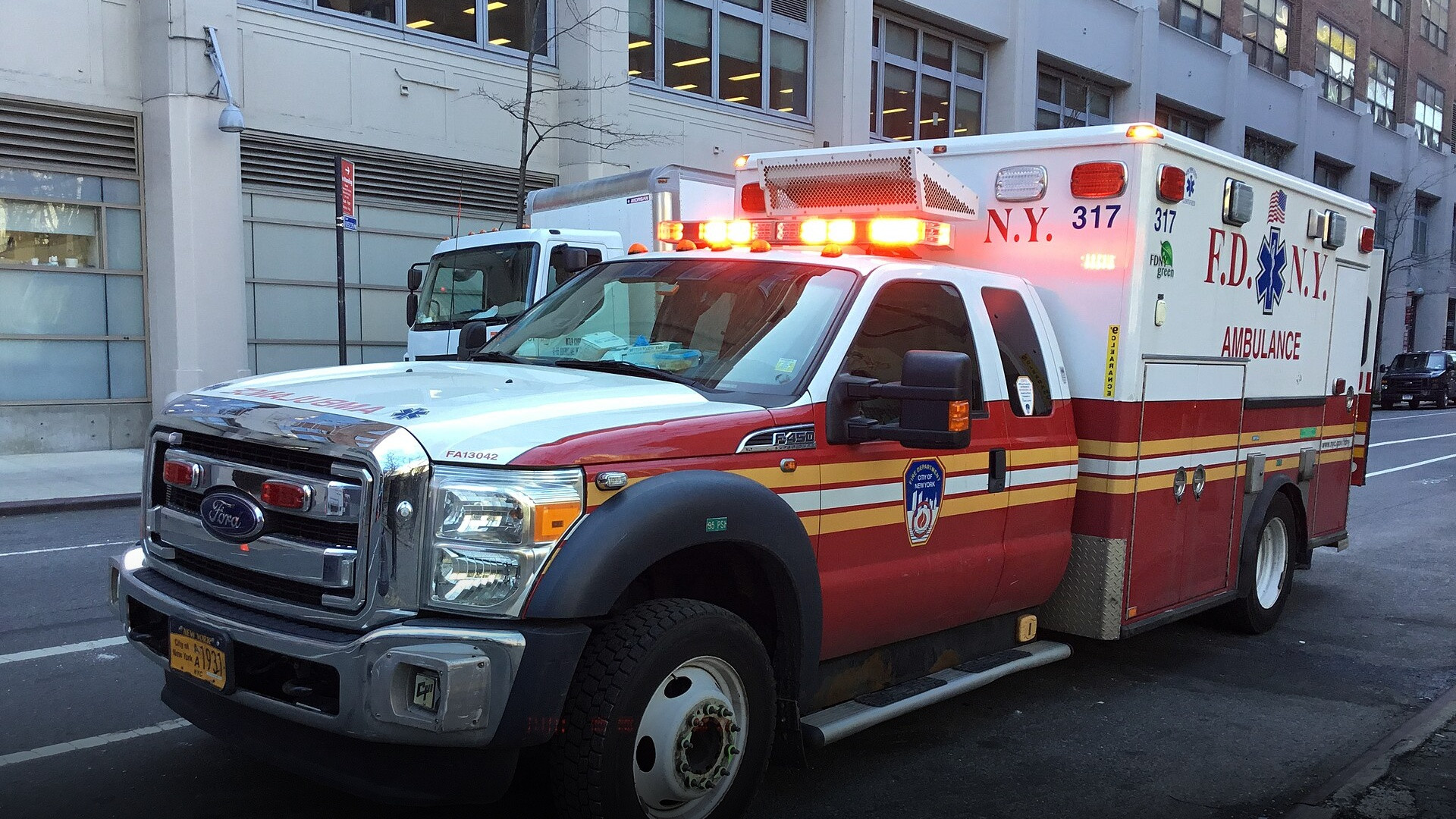 A city FDNY emergency medical services ambulance vehicle on a city street.