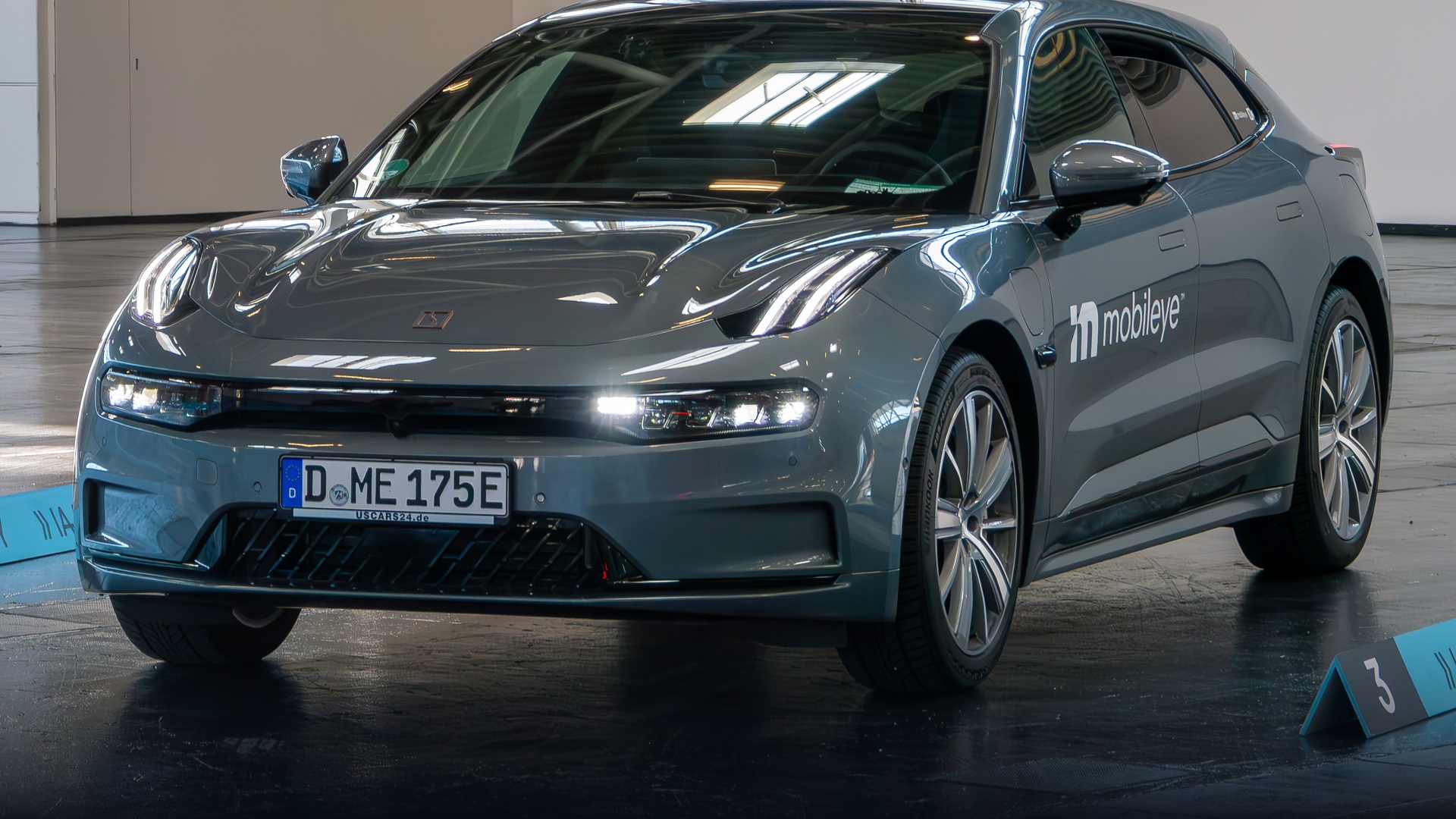 Orange Zeekr 001 electric shooting brake on display at IAA Munich exhibition summit.
