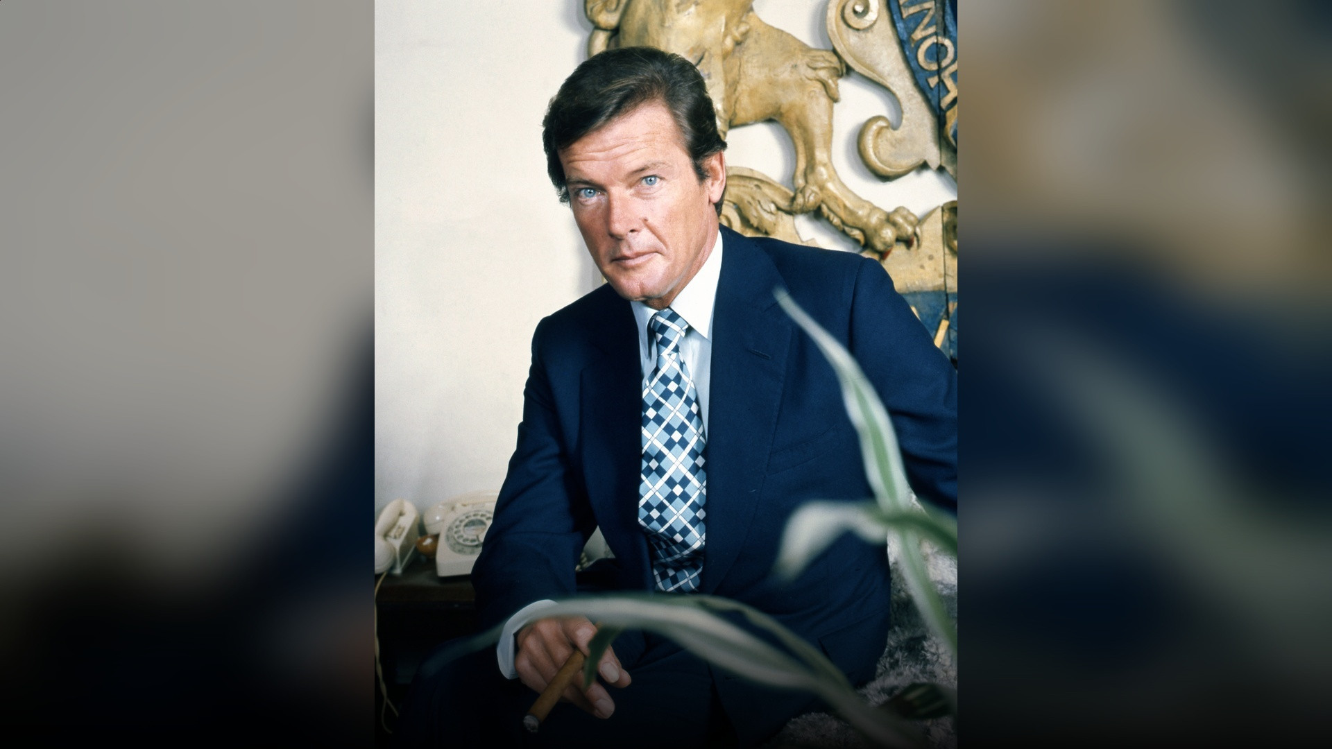 Sir Roger Moore in formal evening wear and black-tie tuxedo.