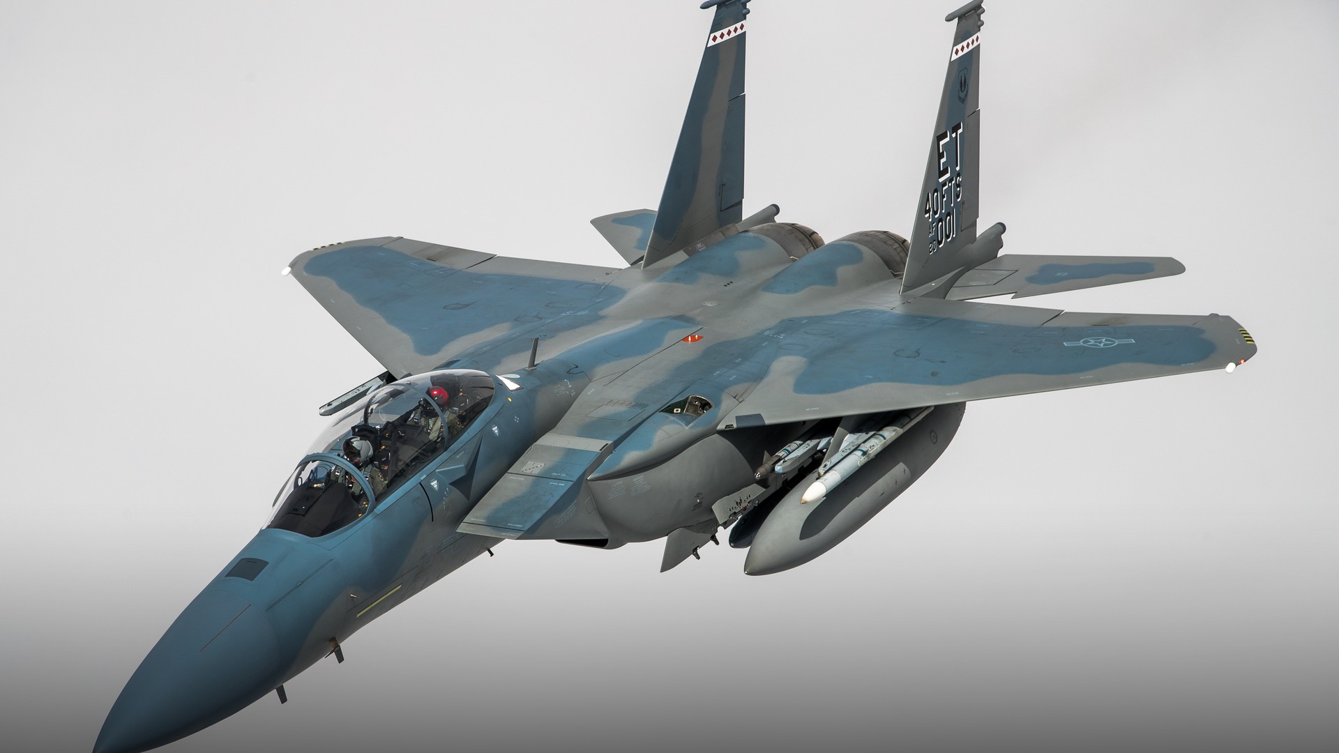 U.S. Air Force F-15EX Eagle II twin-engine air superiority fighter in high-speed flight against overcast sky.