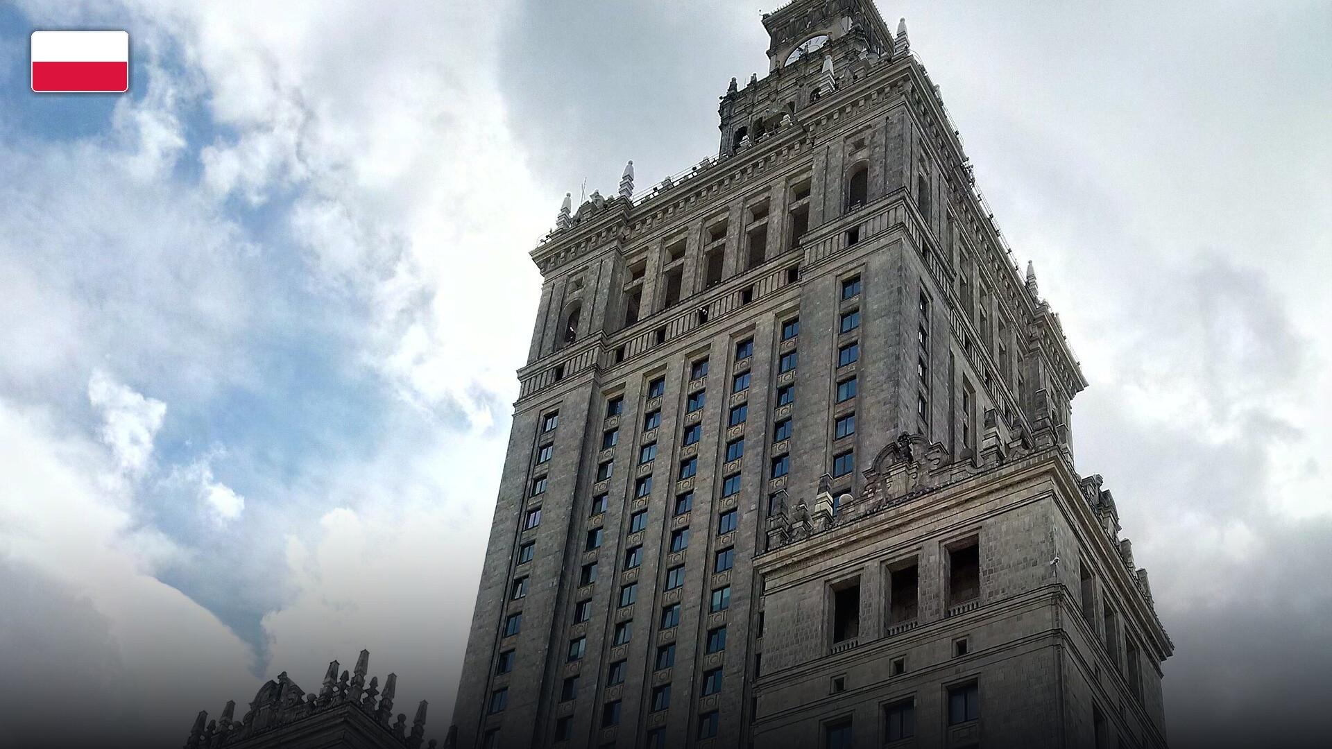 The towering Palace of Culture and Science in central Warsaw, with the flag of Poland.