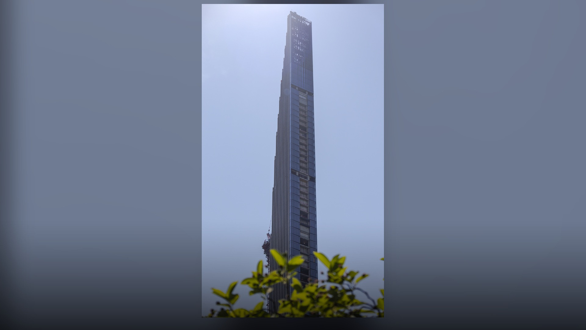 The feather-stepped terracotta crown of 111 West 57th Street tapering into the clouds above Billionaires' Row.