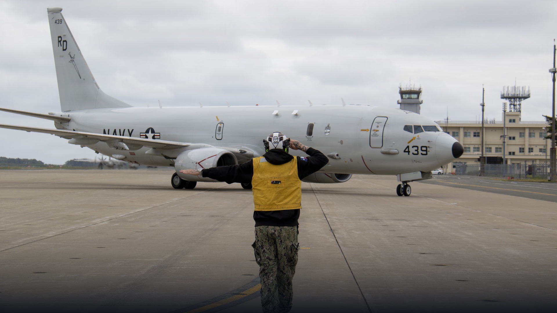 U.S. Navy P-8A Poseidon maritime patrol aircraft flying over ocean waters.