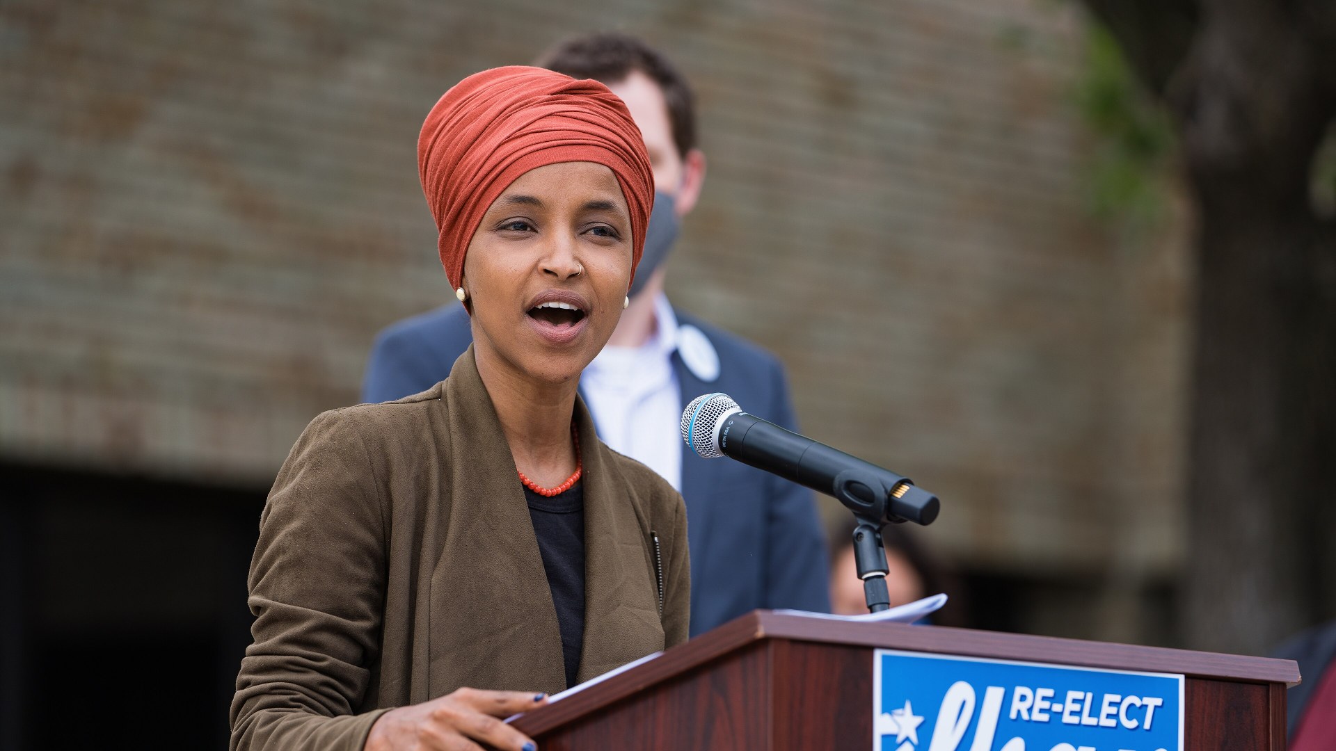 Rep. Ilhan Omar addressing reporters at a press conference podium