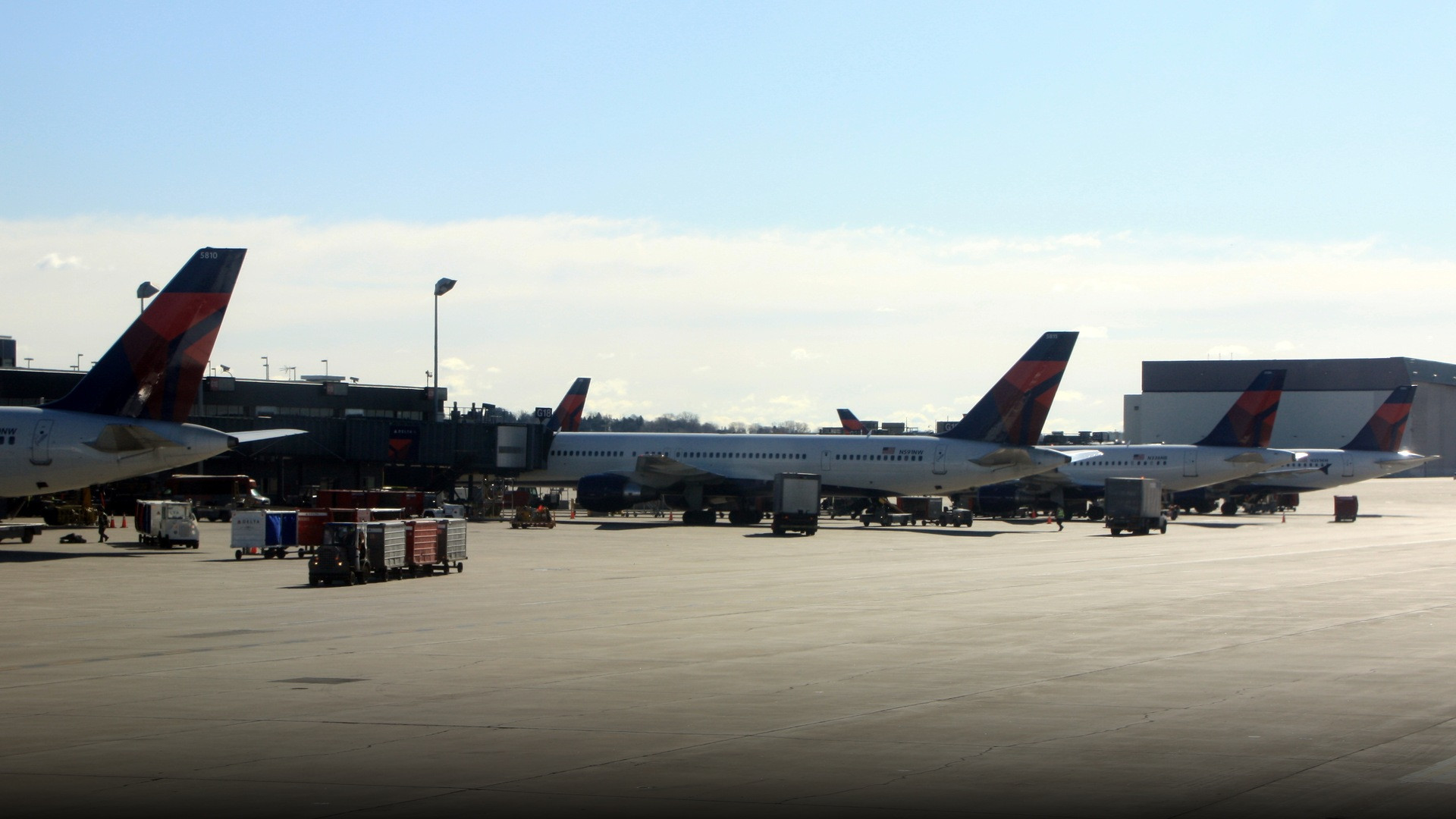 Delta Air Lines passenger jets parked at concourse gates at Minneapolis-Saint Paul International Airport.