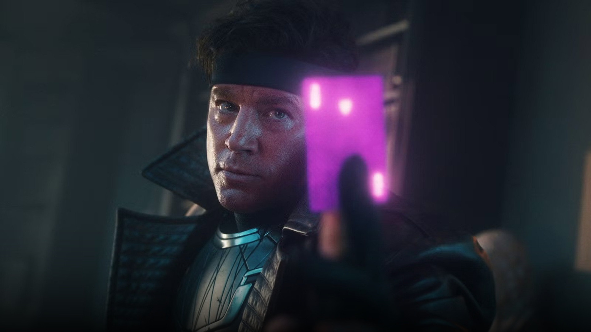 Channing Tatum as Gambit holding a glowing purple kinetic playing card in battle armor.