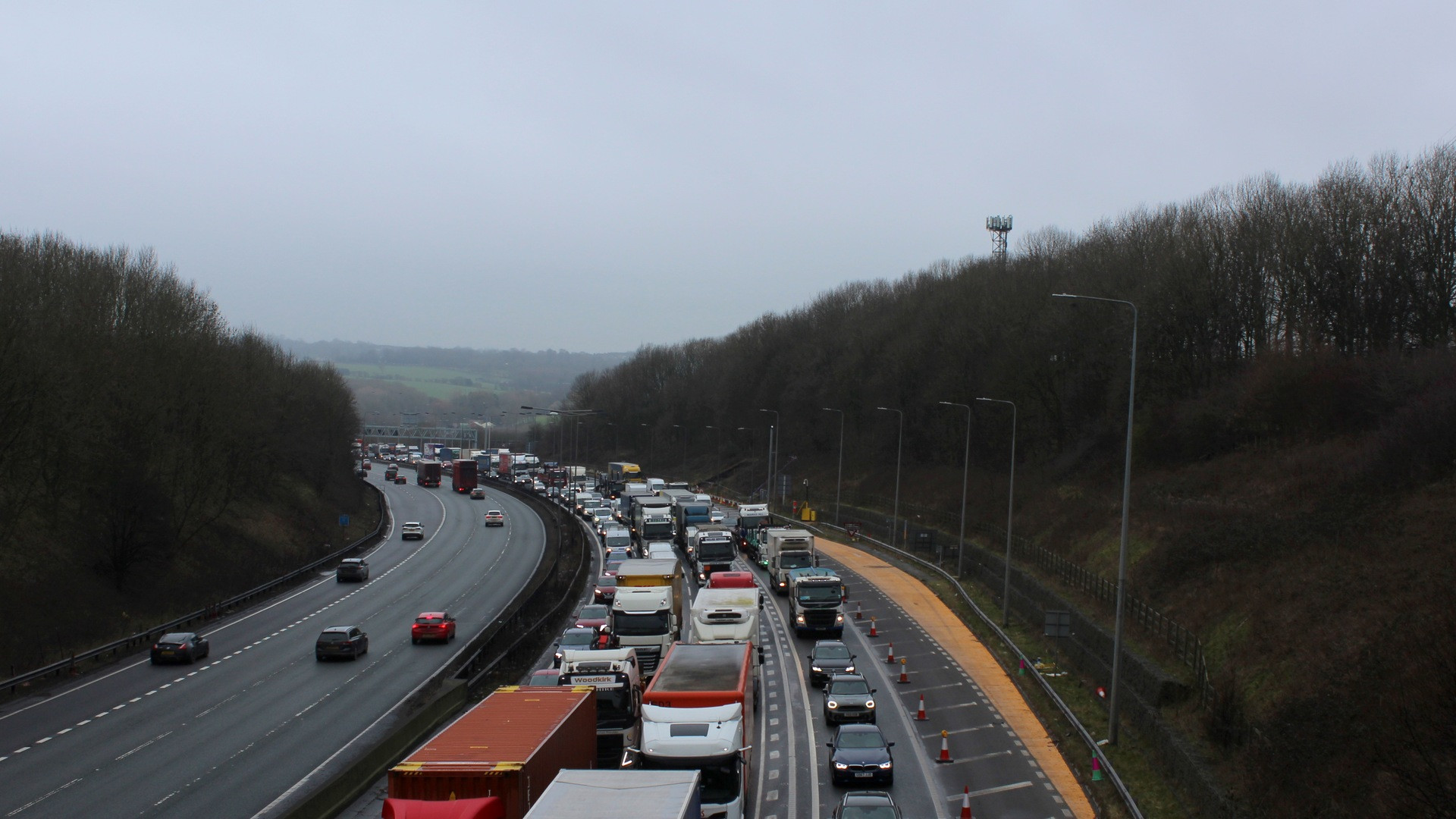 Dense line of passenger cars and commuters stuck in evening peak hour traffic congestion.