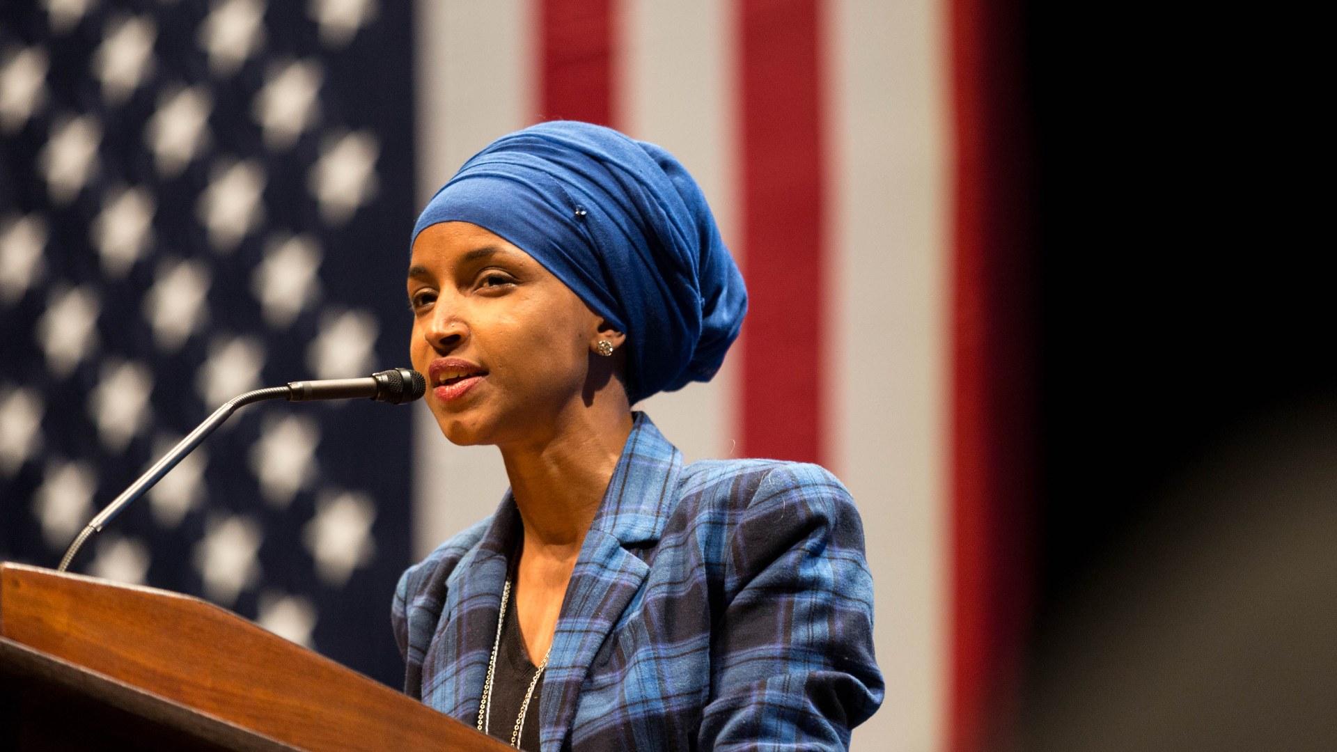 Ilhan Omar speaking at a university event in Minnesota
