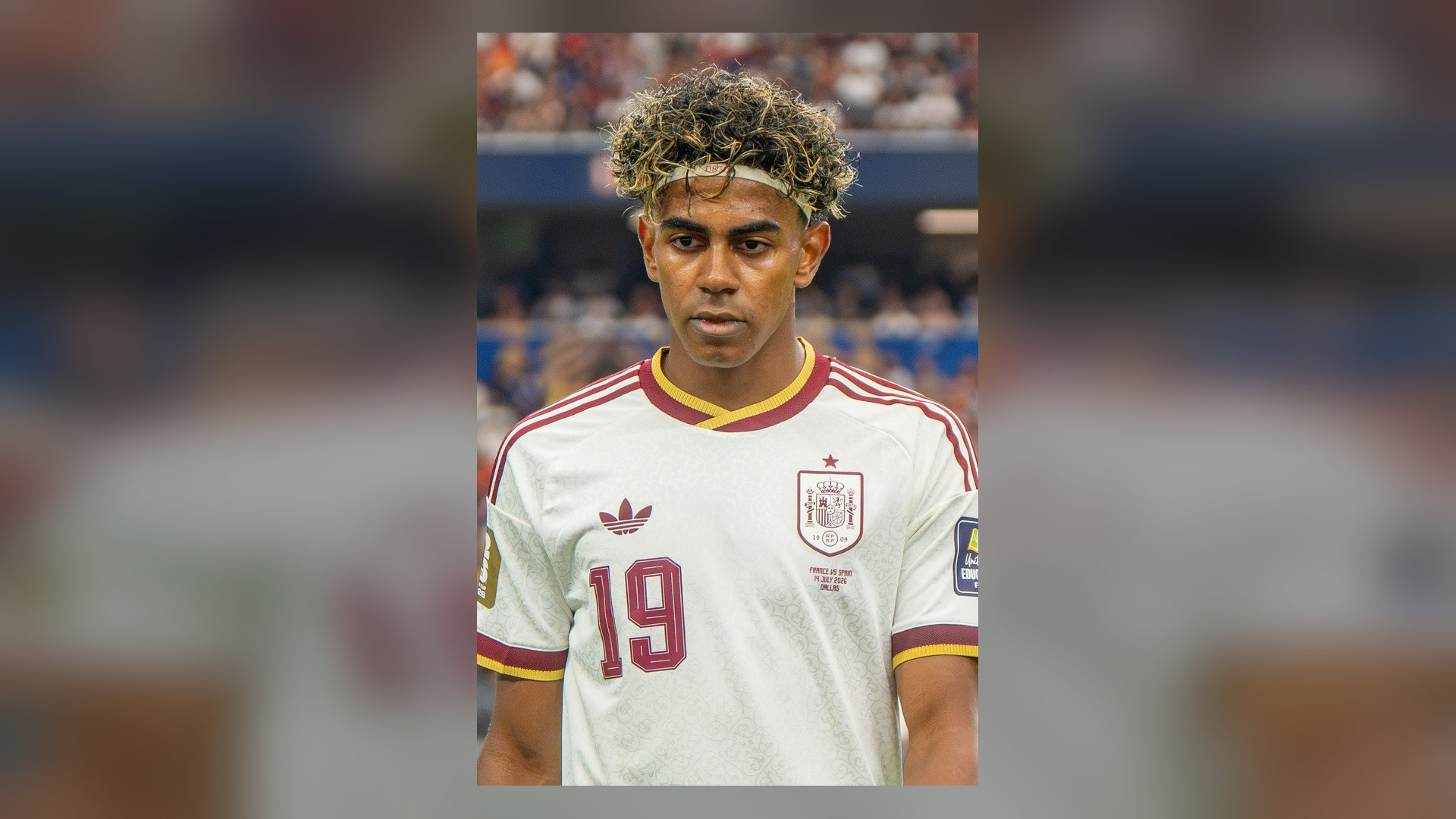 Portrait of Spanish winger Lamine Yamal in white jersey.